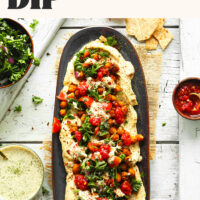 Platter of chickpea shawarma dip with pita chips around it