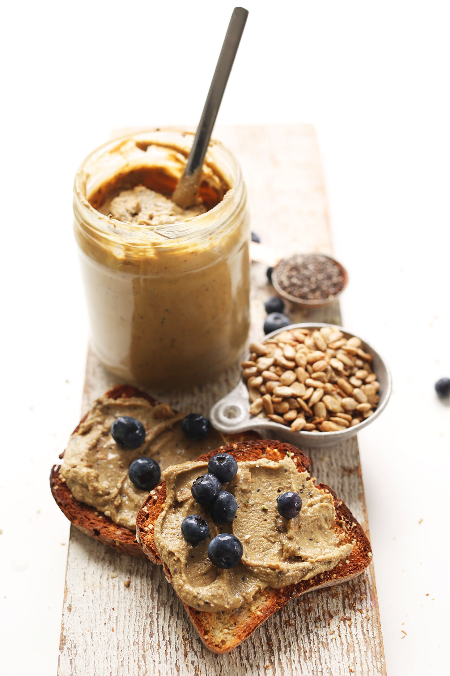 Slices of gluten-free toast topped with homemade Sunflower Seed Butter and blueberries
