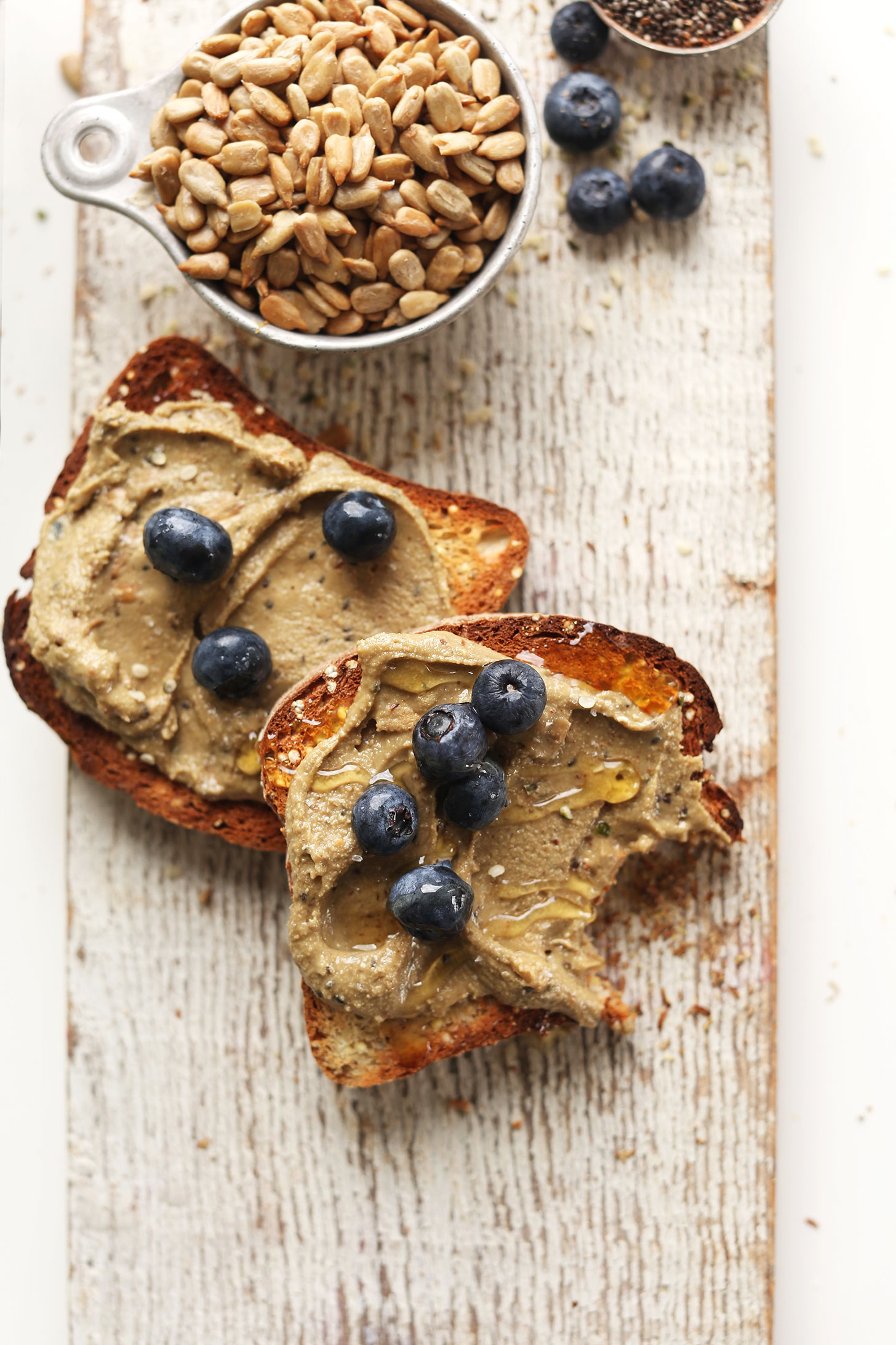 Partially eaten gluten-free toast topped with our Sunflower Seed Butter recipe