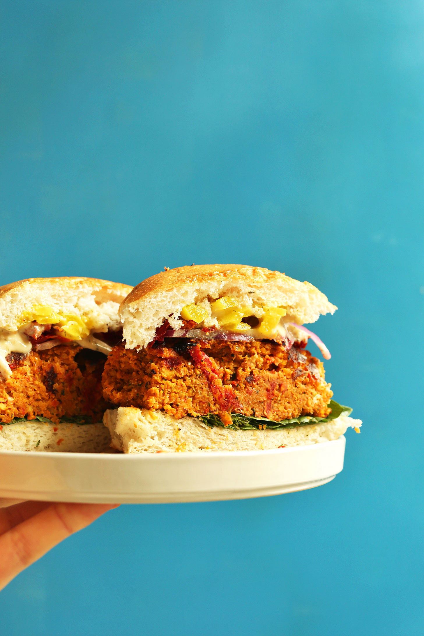 Halved Sun-dried Tomato Herbed Chickpea Burger for a delicious plant-based dinner