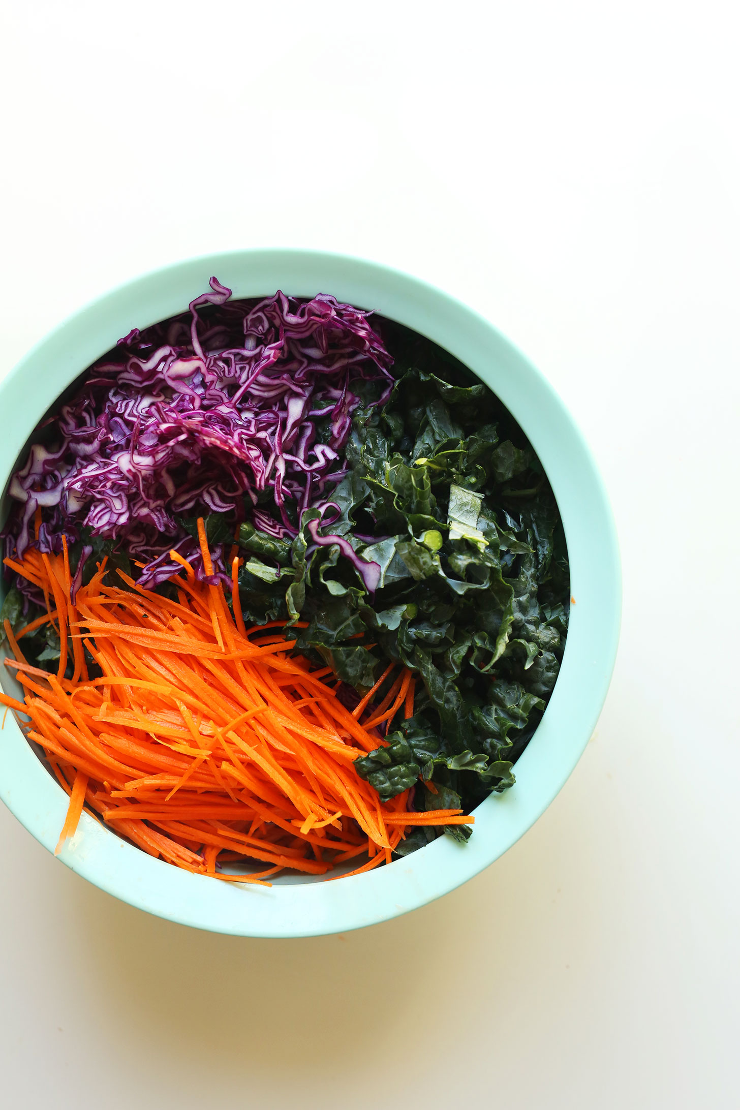 Big salad bowl with kale, red cabbage, and carrots