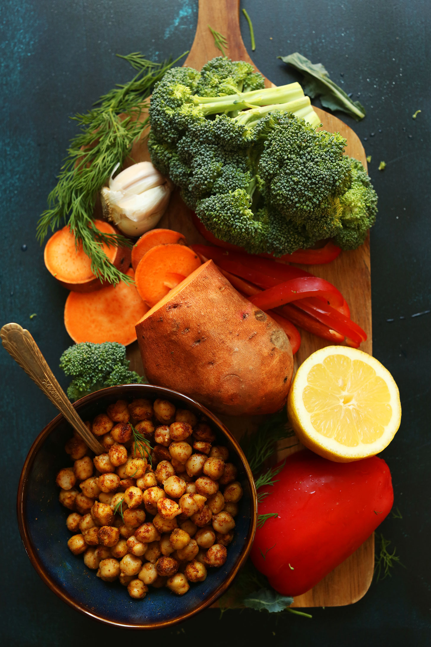 Chickpeas, lemon, sweet potato, bell pepper, broccoli, and garlic for making a healthy vegan meal