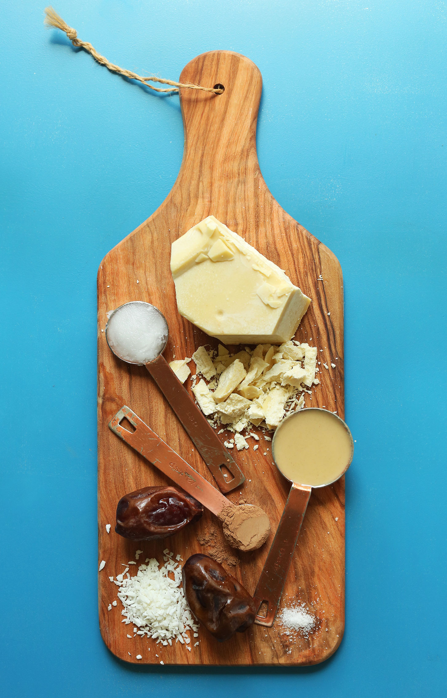 Dates, coconut, tahini, cinnamon, cacao butter, and coconut oil for making Tahini-Stuffed Dates
