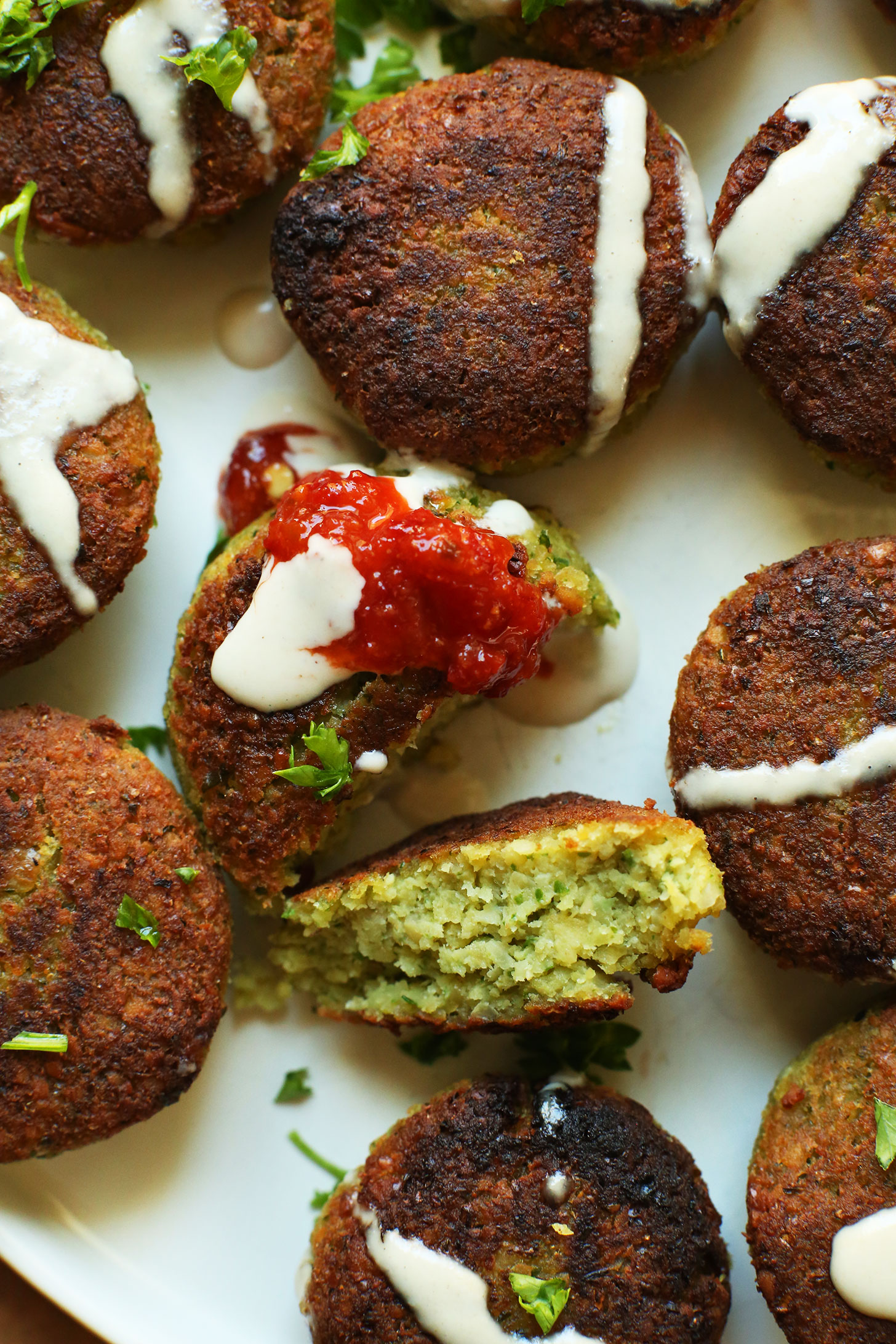 Delicious bites of gluten-free vegan falafel drizzled with tahini sauce