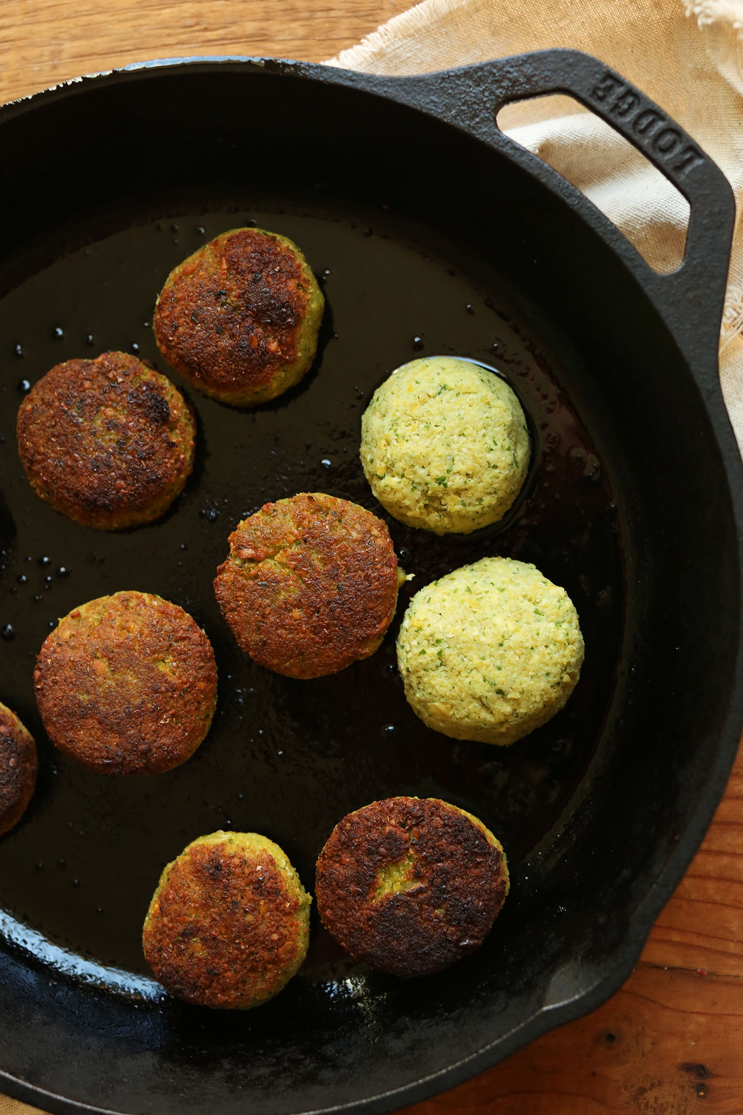 Browning gluten-free vegan falafel in a cast-iron skillet for a plant-based meal