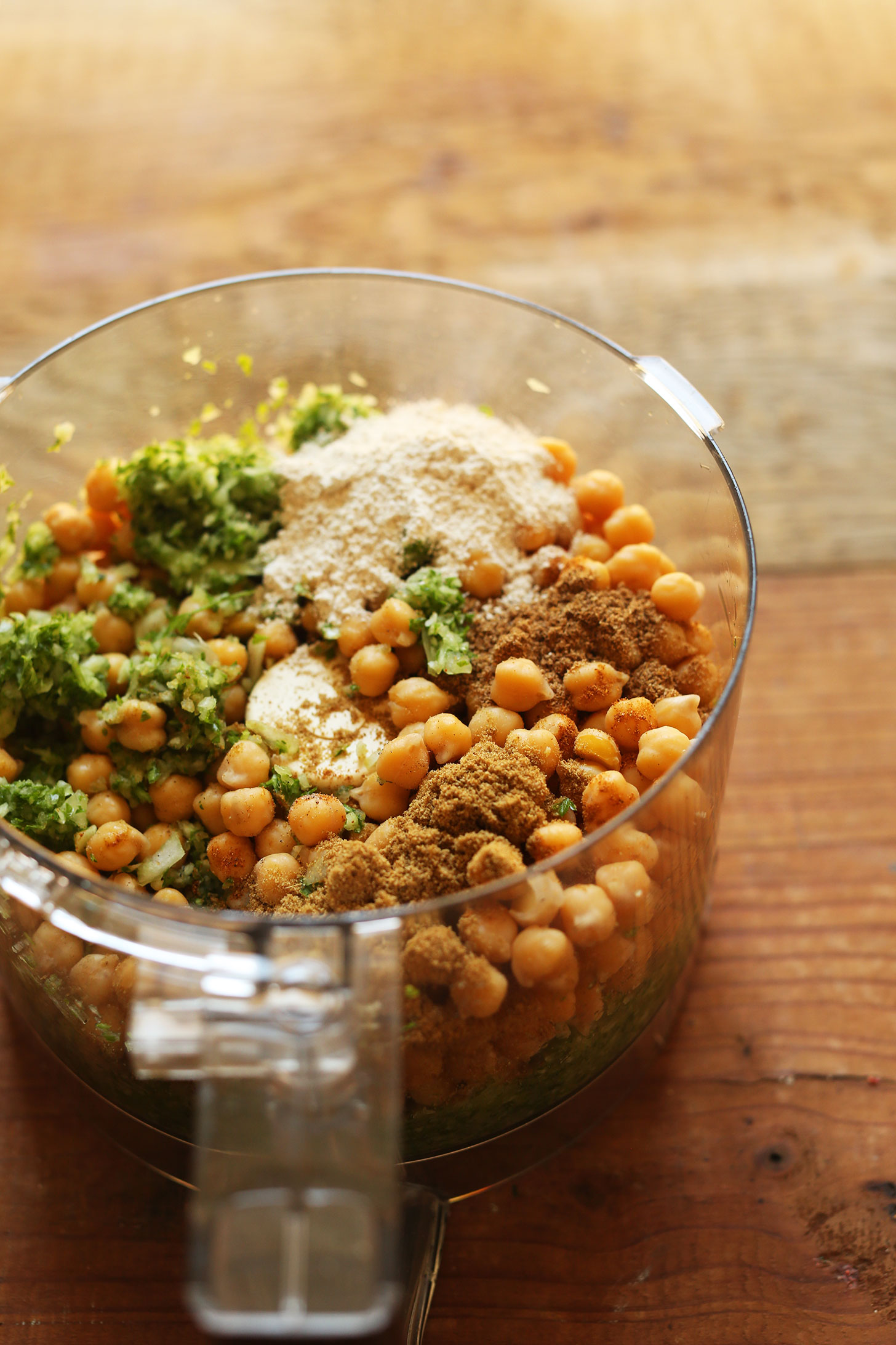 Food processor with ingredients for making gluten-free vegan falafel for a plant-based meal