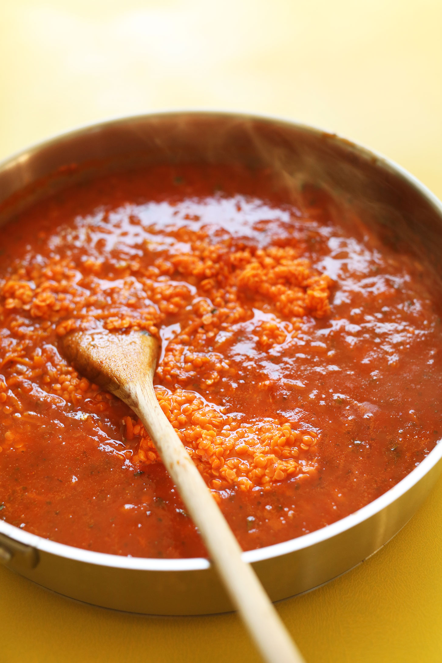 Stirring together ingredients for our healthy Vegan Lentil Bolognese recipe