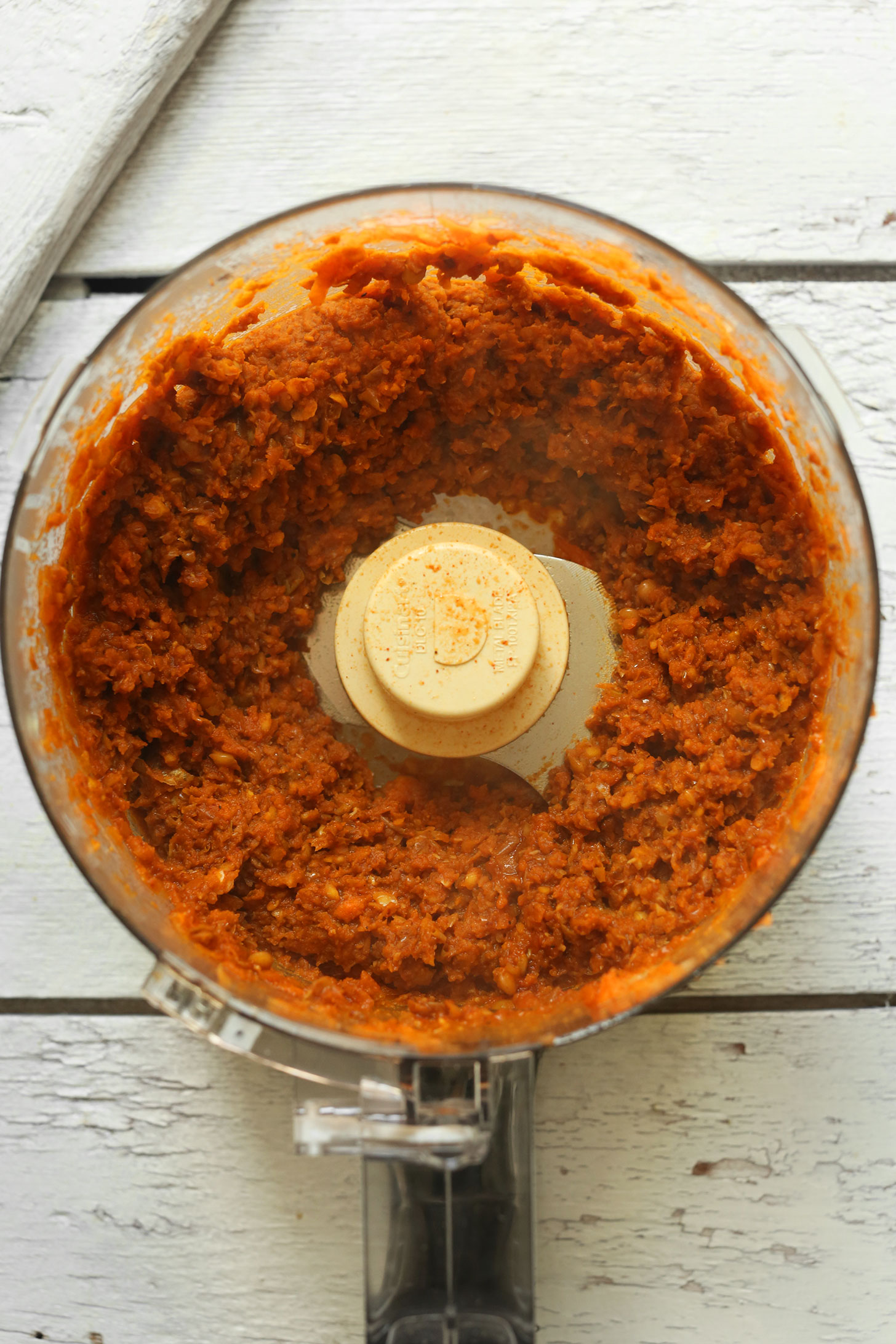 Using a food processor to mix ingredients for vegan pulled pork sandwich filling