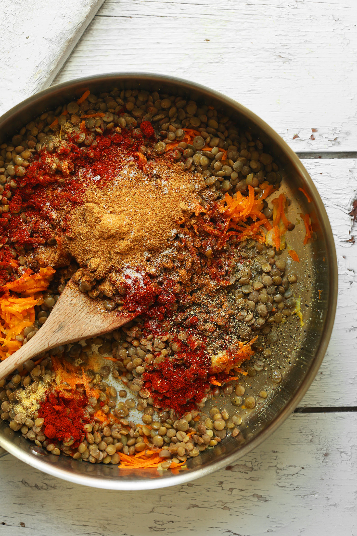 Mixing together lentils, spices, and carrots for making homemade Vegan Pulled Pork Sandwiches