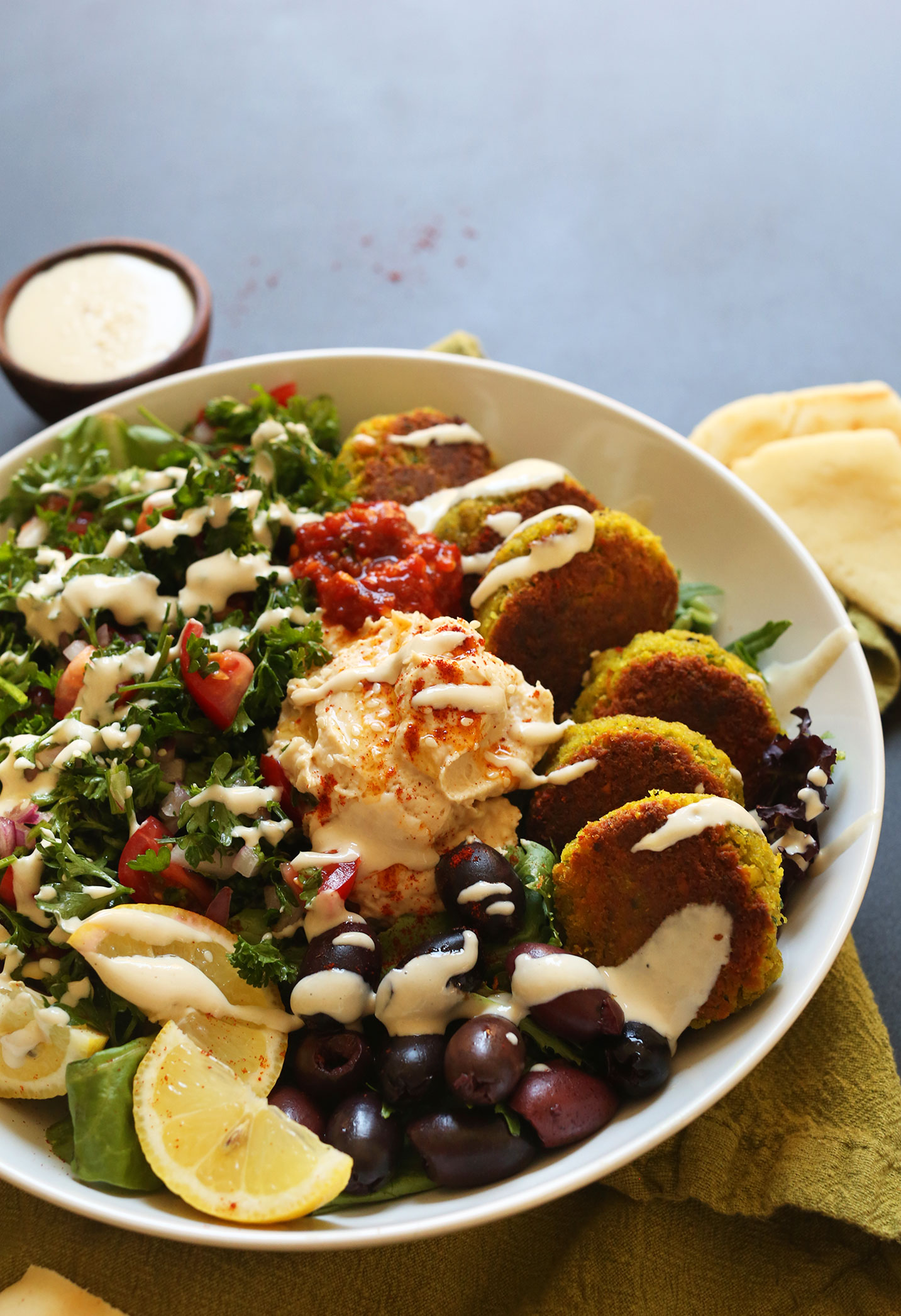 Tahini sauce drizzled over our vegan Mediterranean Bowl recipe