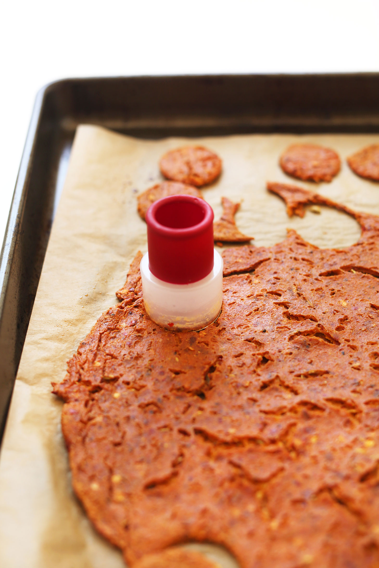 Using a cookie cutter to make circles of vegan pepperoni