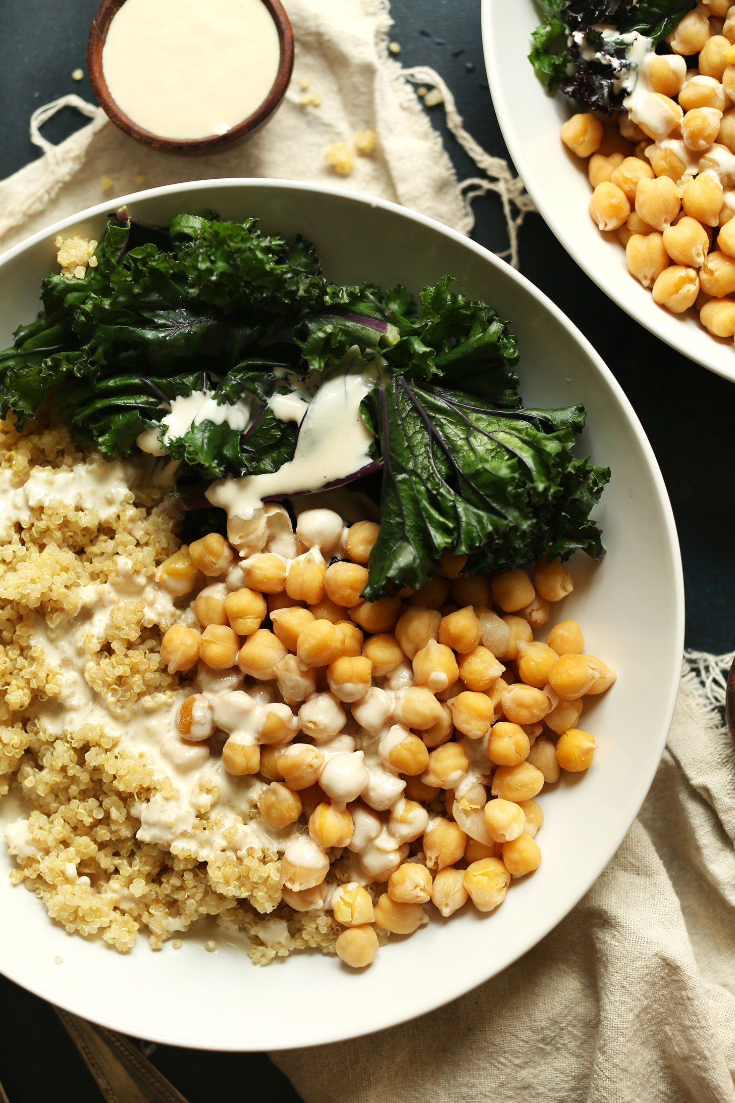 Servings of our Quinoa Chickpea Buddha Bowls with Kale and Tahini Sauce for a delicious plant-based meal