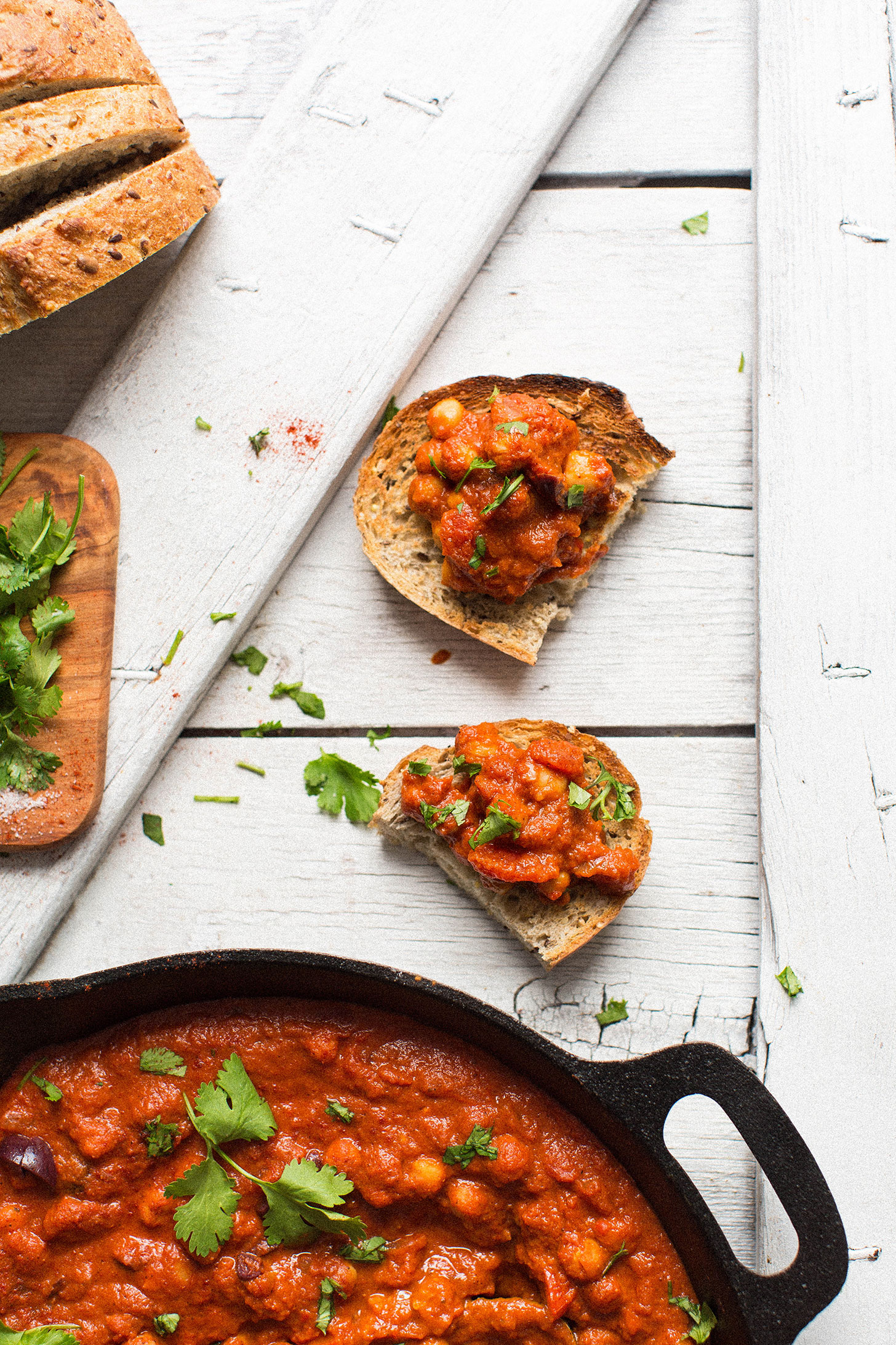 Slices of crispy gluten-free bread with vegan Chickpea Shakshuka