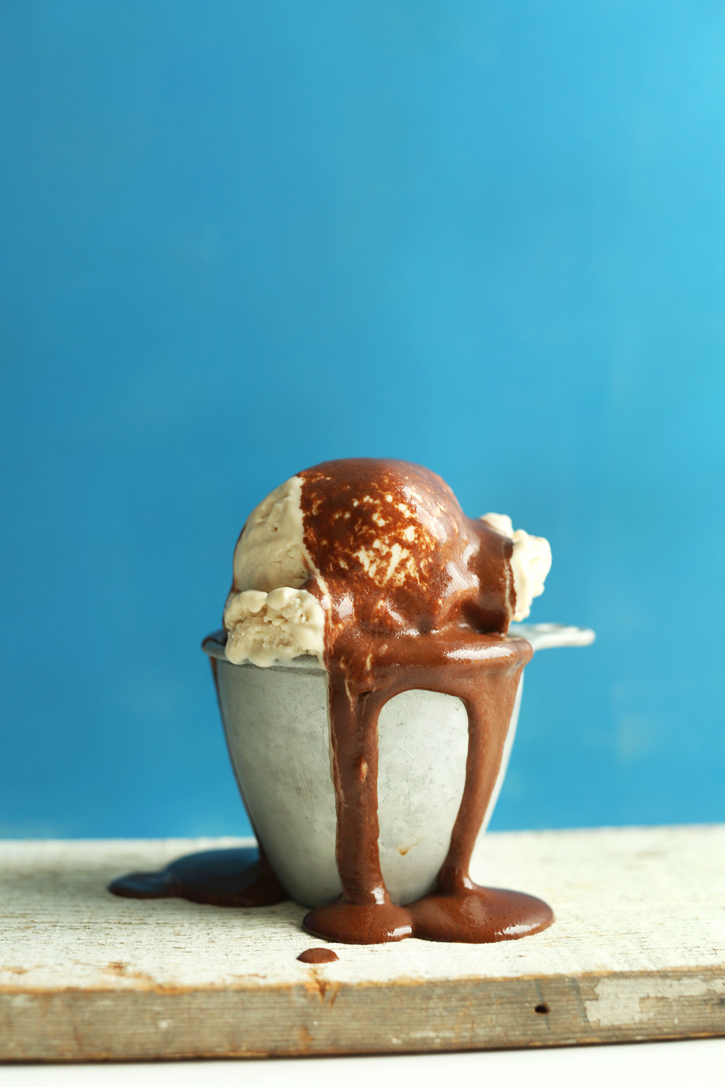 Close up shot of our vegan chocolate syrup recipe drizzled over ice cream