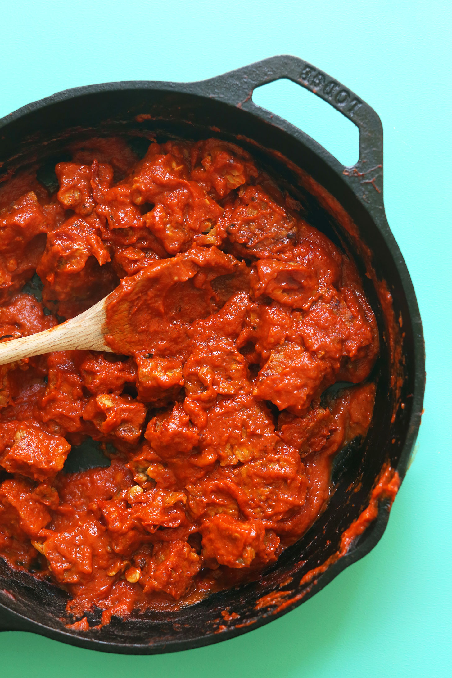 Cast-iron skillet with tempeh coated in smoky sauce for a healthy vegan meal