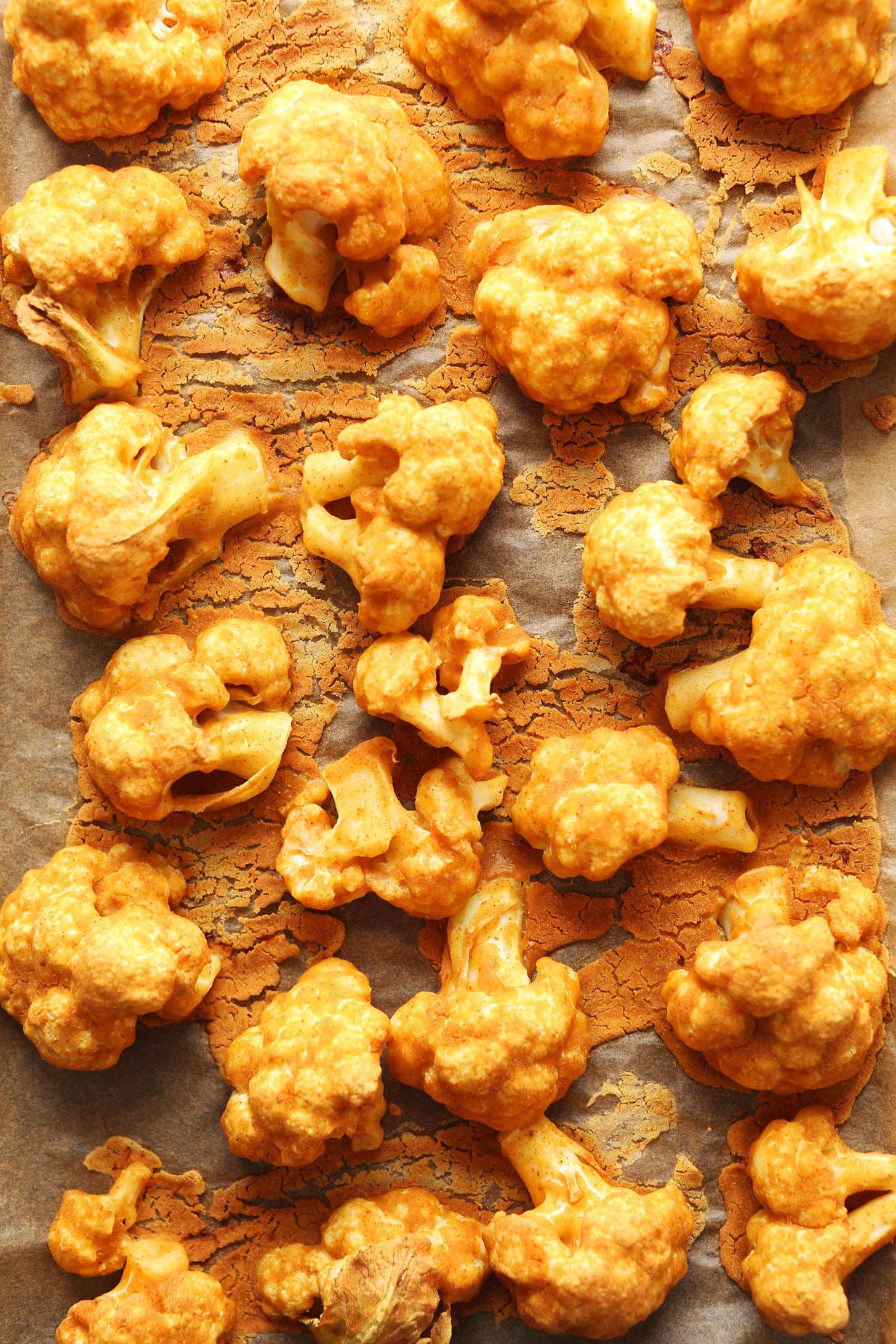 Parchment-lined baking sheet with freshly baked Red Curry Cauliflower Wings
