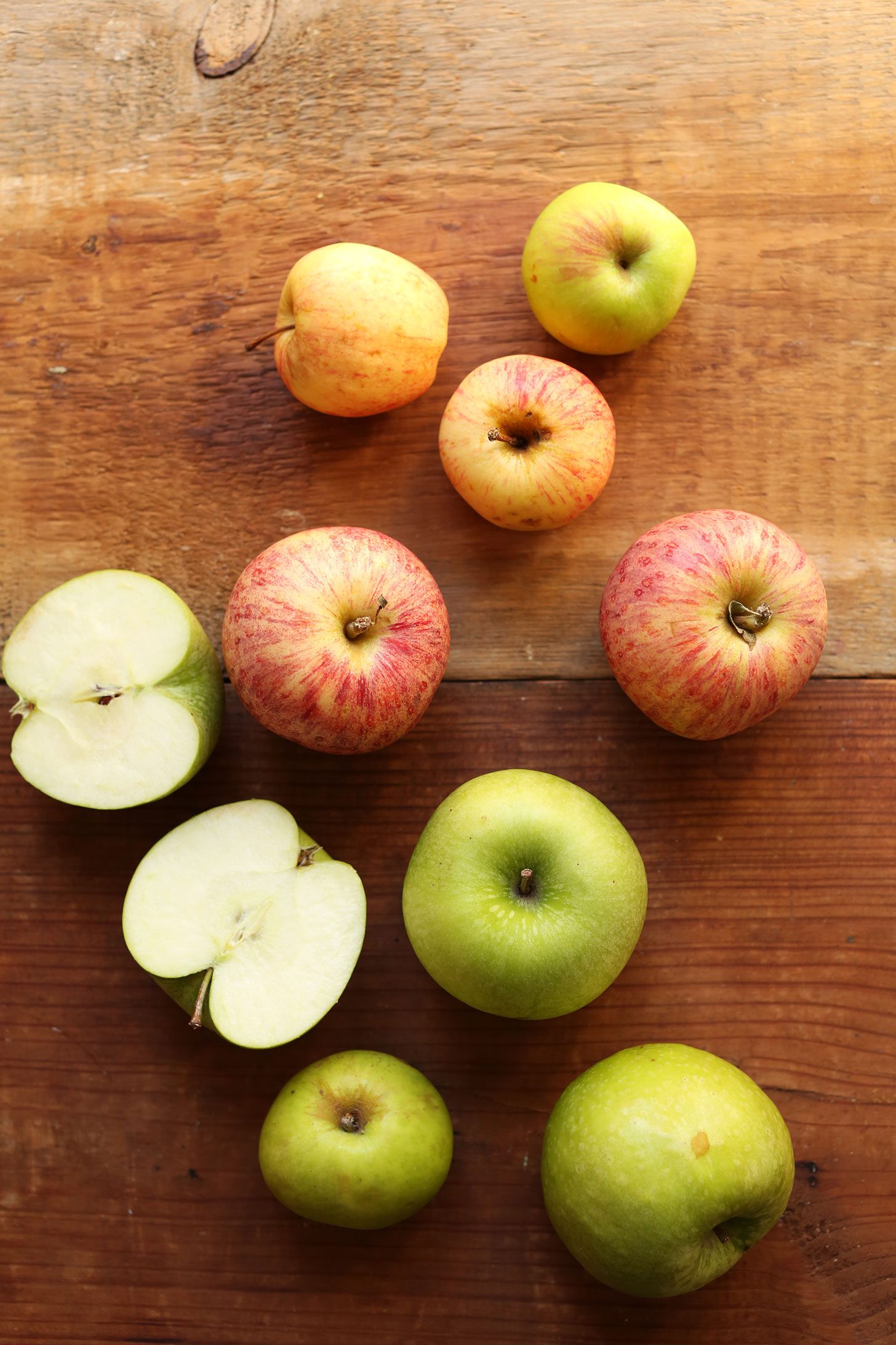 Wood board with a collection of apples for making delicious apple pie sundaes