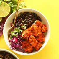 Gold fork in a Smoky Tempeh Burrito Bowl topped with fresh cilantro