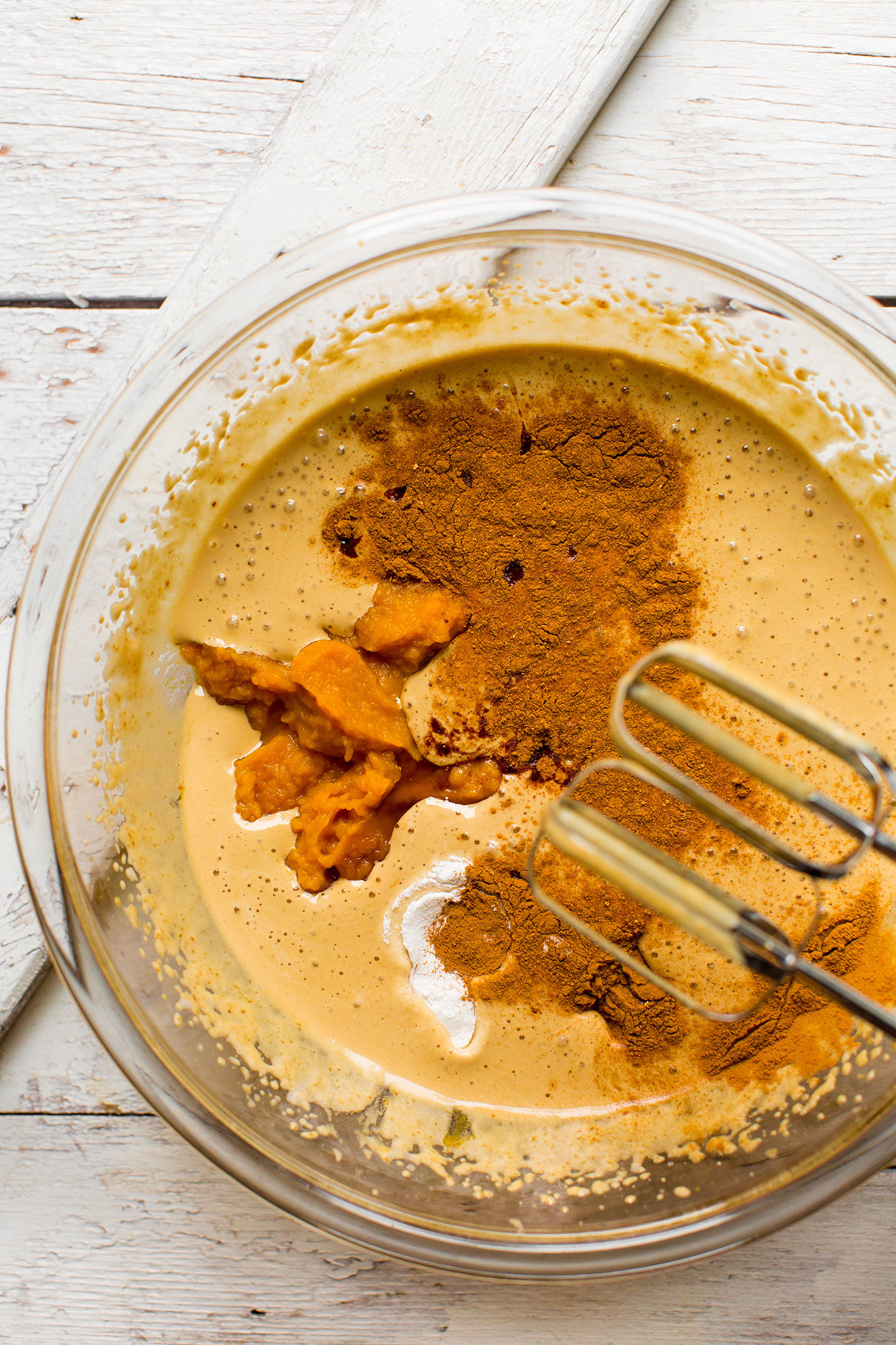 Using a hand mixer to combine ingredients for our easy 1-bowl Pumpkin Cake recipe