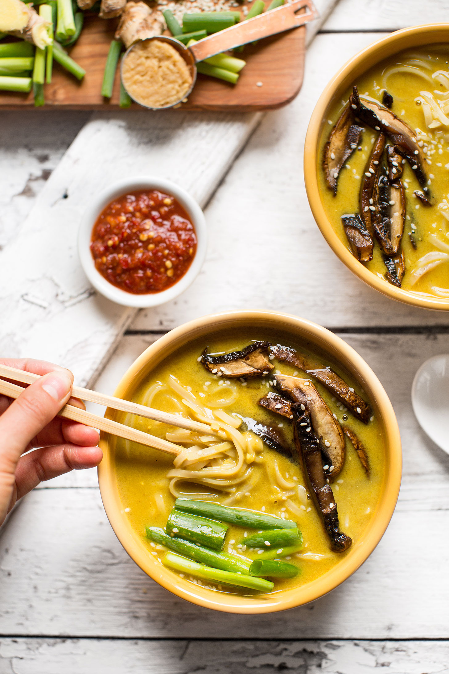 Using chopsticks to grab a bite of gluten-free vegan Coconut Curry Ramen