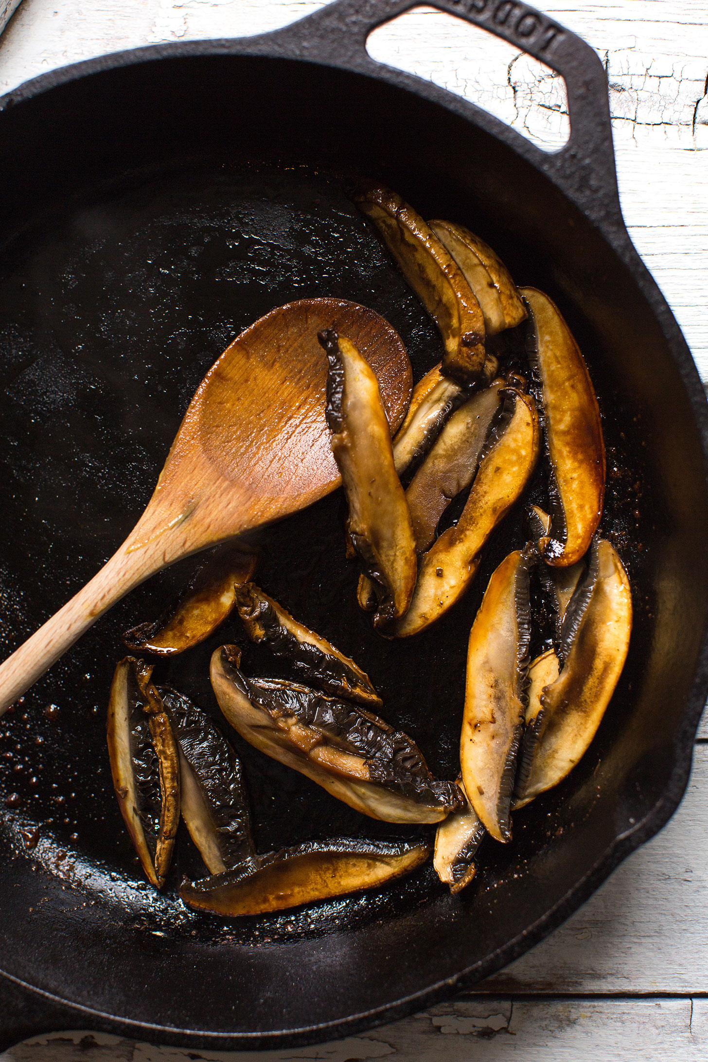 Sautéing mushrooms in a cast-iron skillet for our gluten-free vegan Coconut Curry Ramen recipe