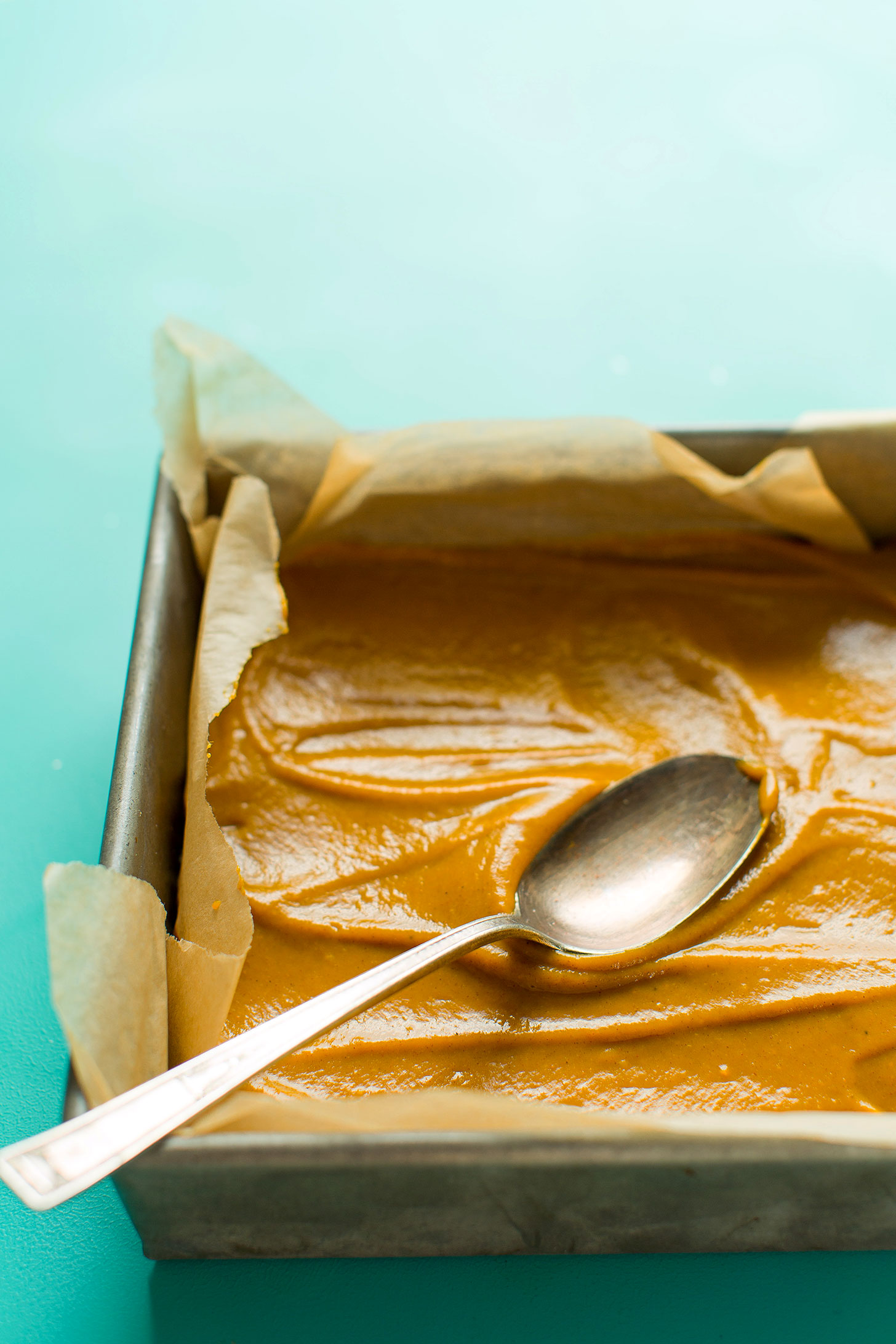 Spreading naturally-sweetened pumpkin pie bar filling over gluten-free crust