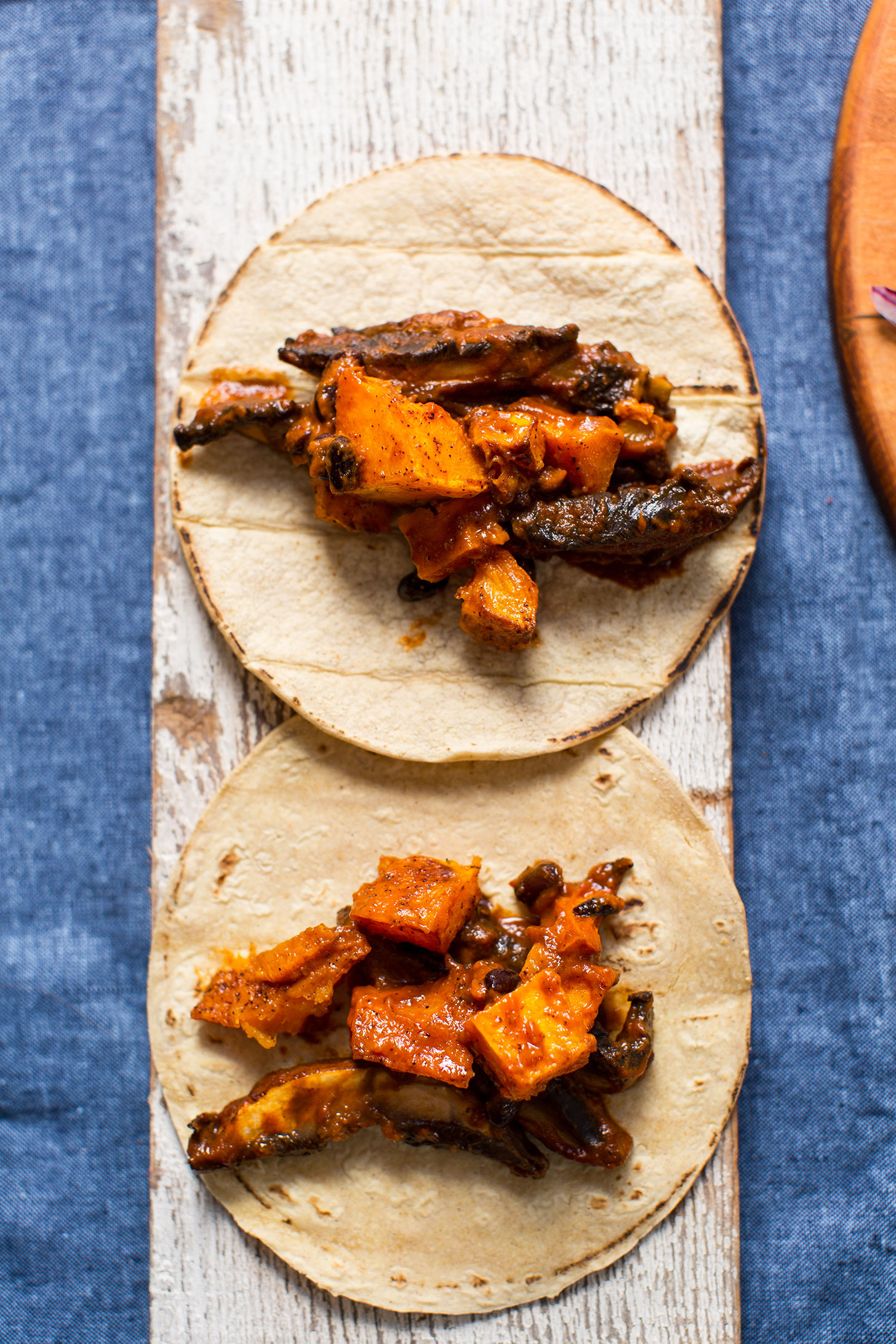 Amazing squash and mushroom vegan tacos on a wood plank