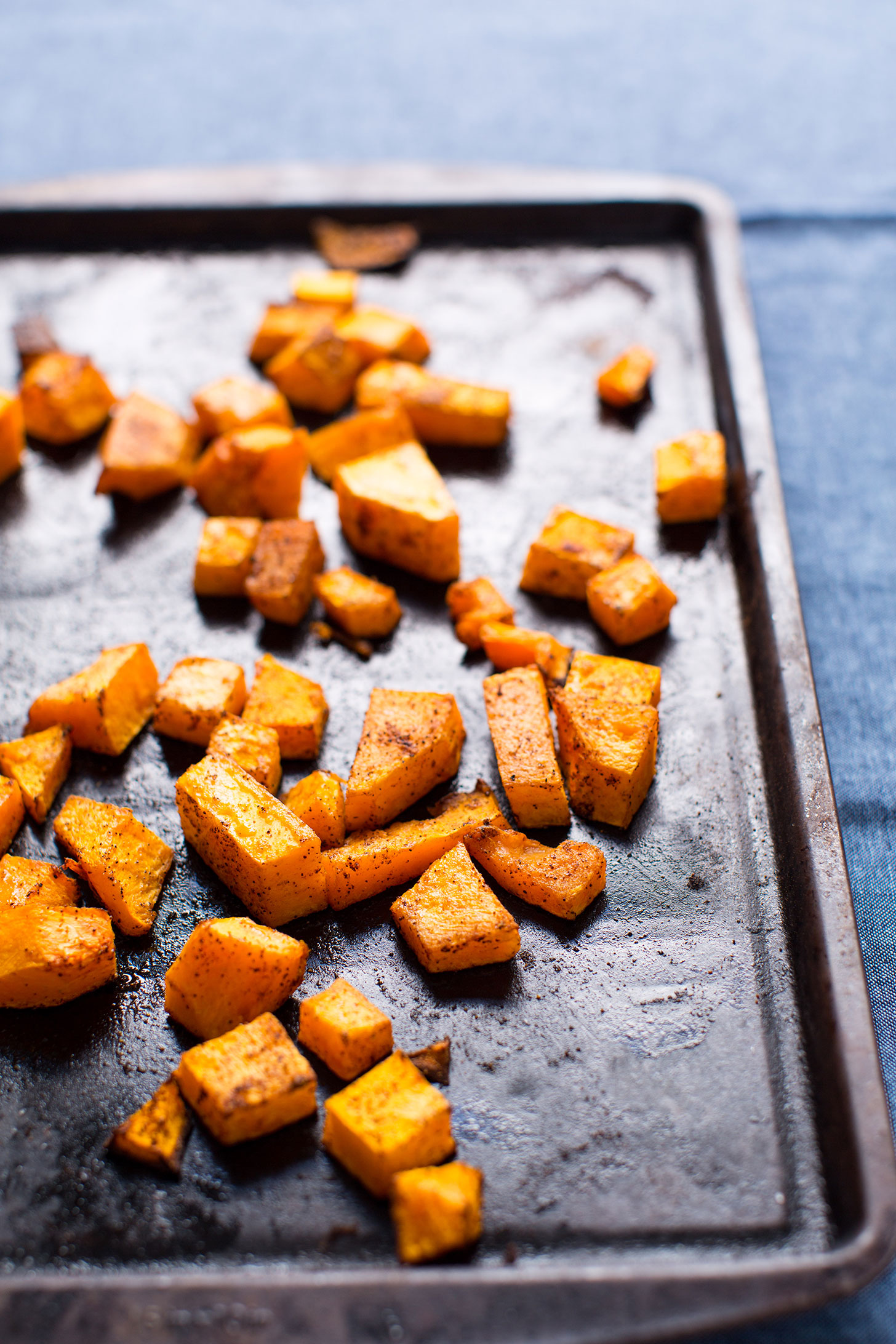 Baking sheet with freshly roasted spiced butternut squash for easy vegan tacos