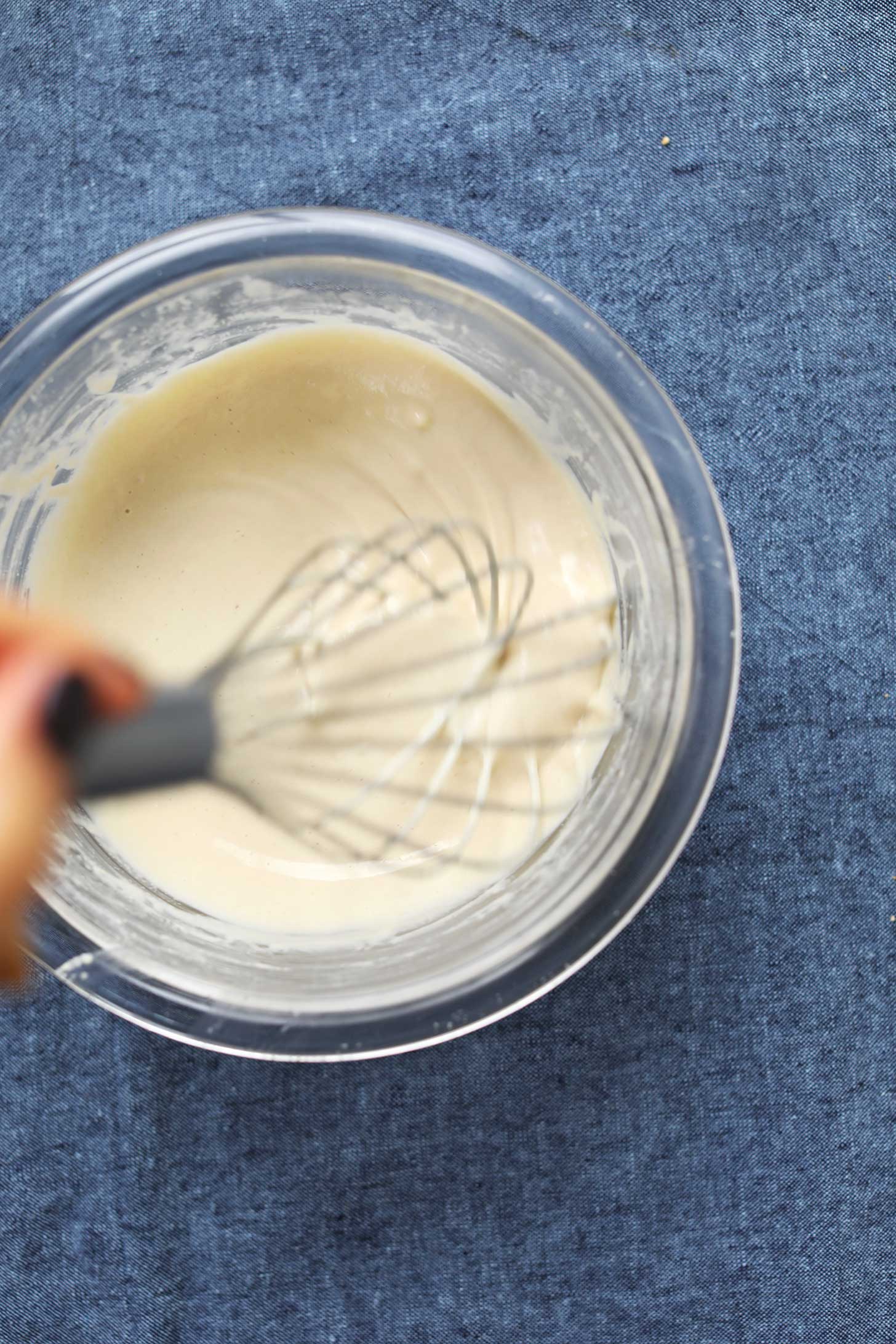 Whisking dressing ingredients for a healthy kale salad recipe