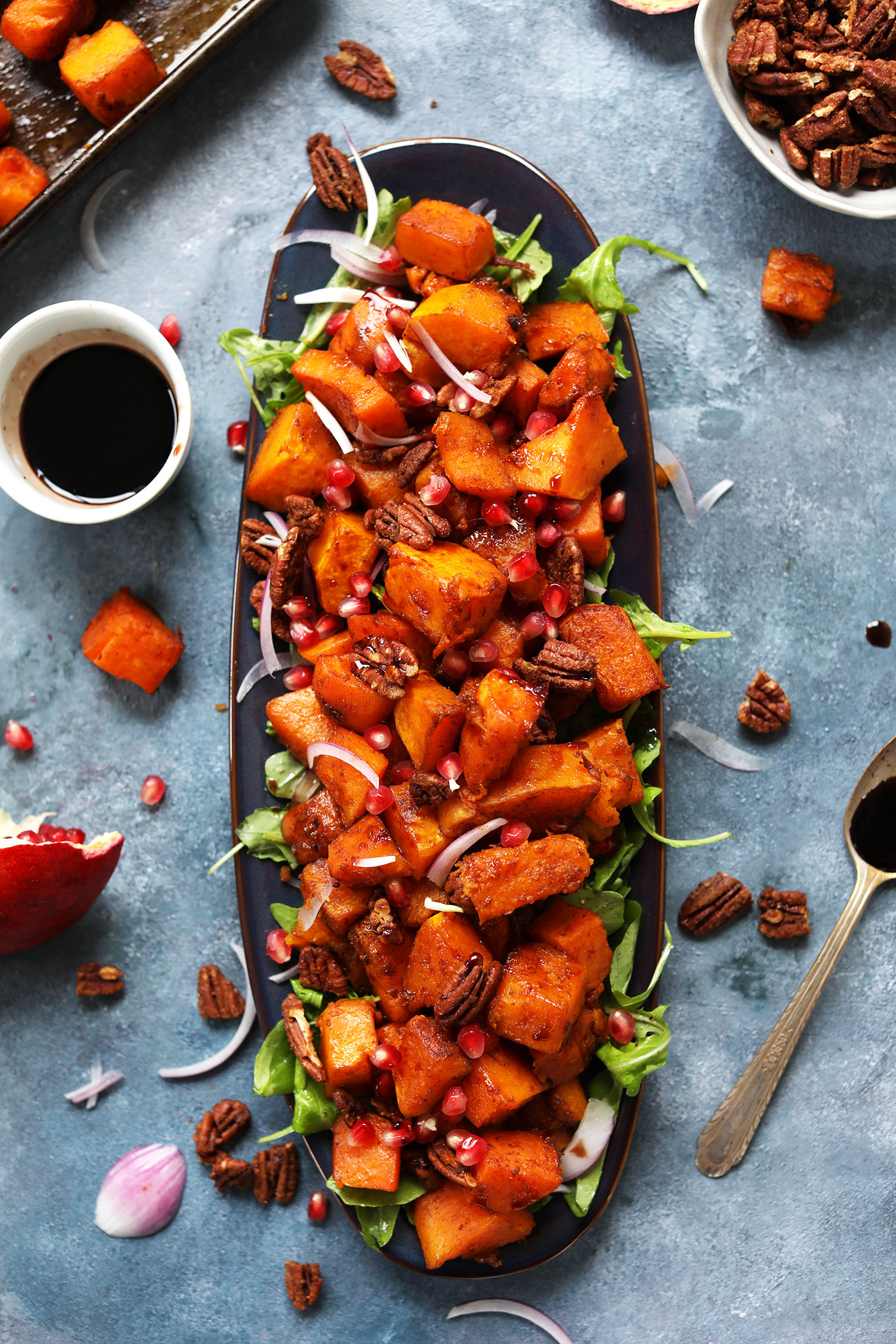Serving platter filled with Sweet Spicy Roasted Squash Salad topped with Cinnamon Sugar Pecans