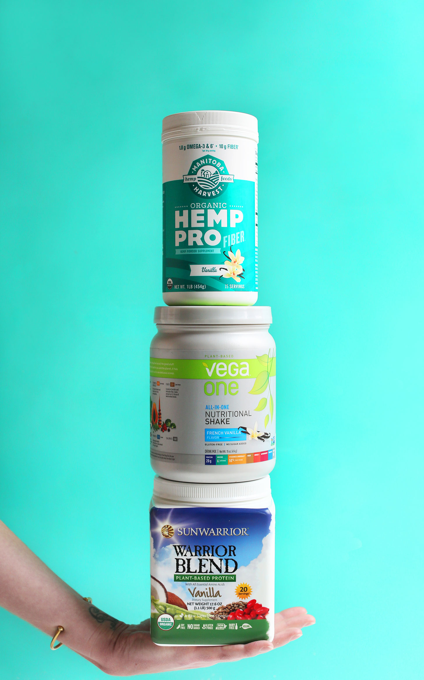 Stack of protein powders as part of an extensive review of vegan protein powders