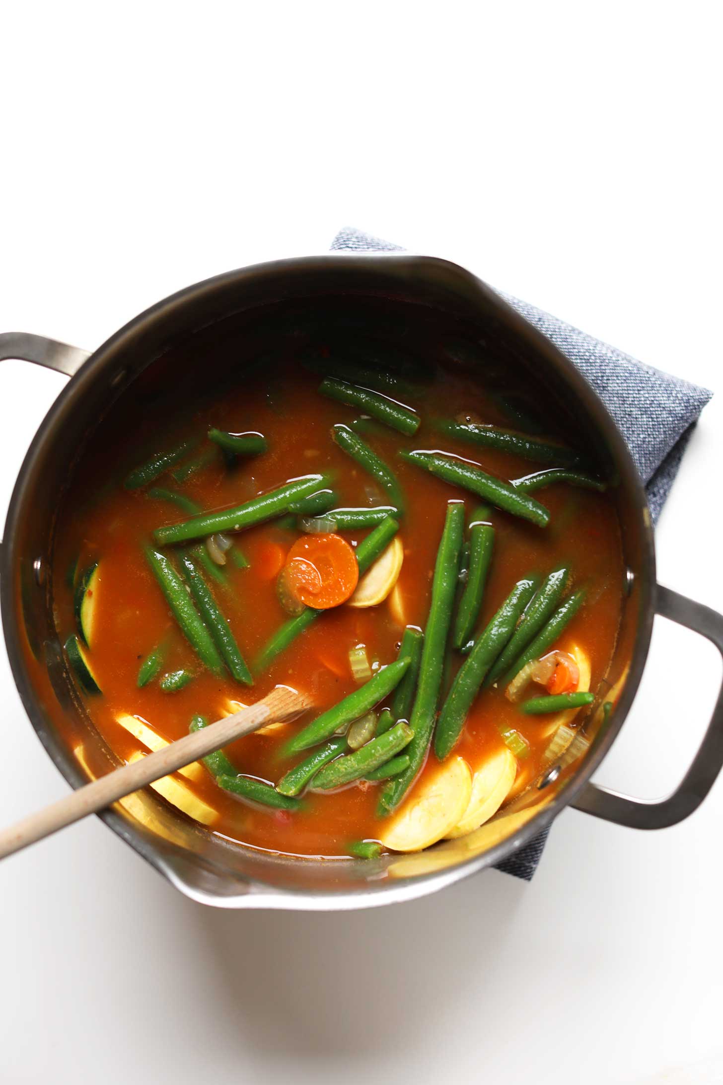 Pot of Mung Bean Vegetable Minestrone with fresh green beans floating at the top