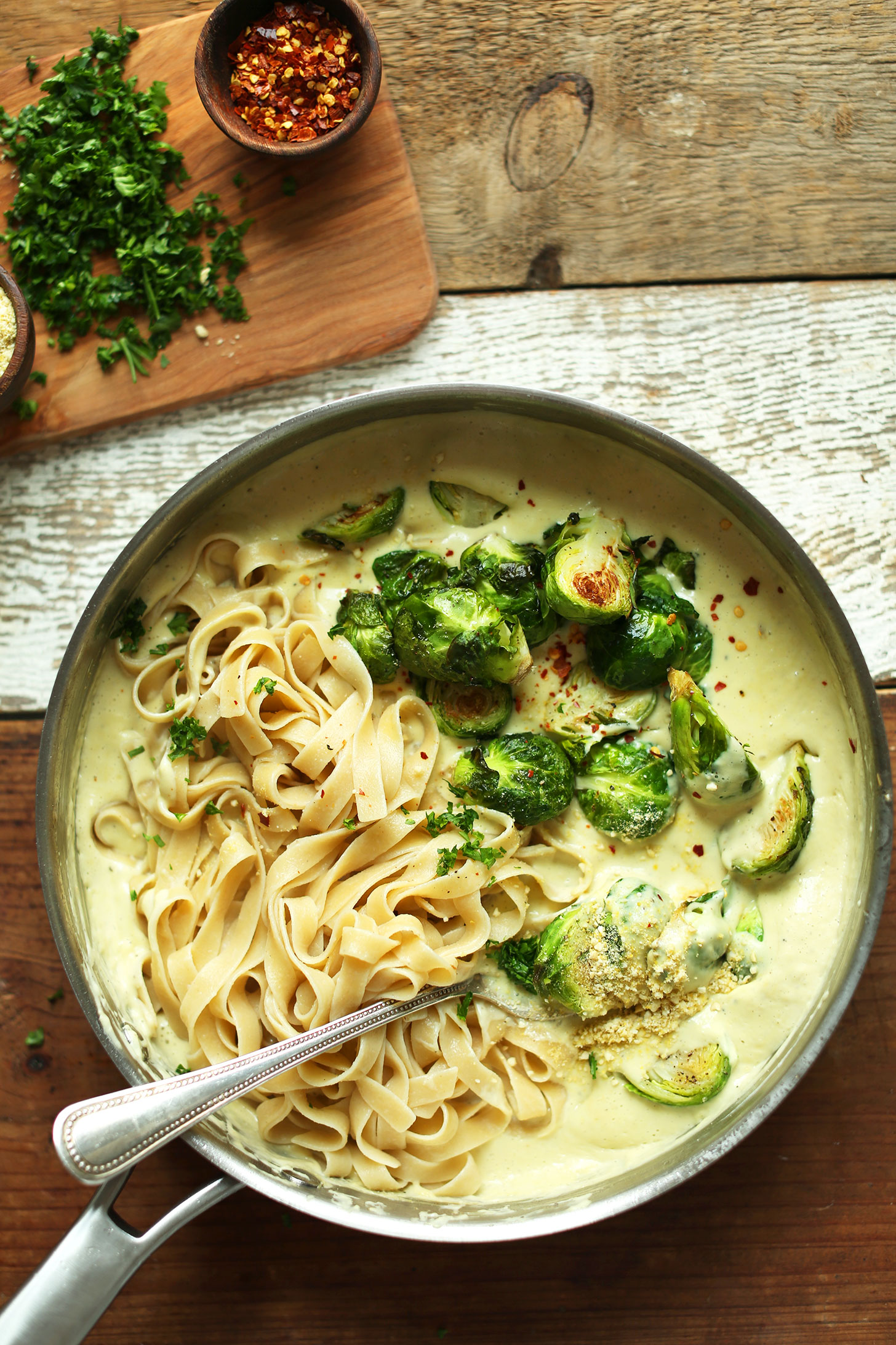 Stirring a pan of White WIne + Garlic Pasta with Roasted Brussels Sprouts