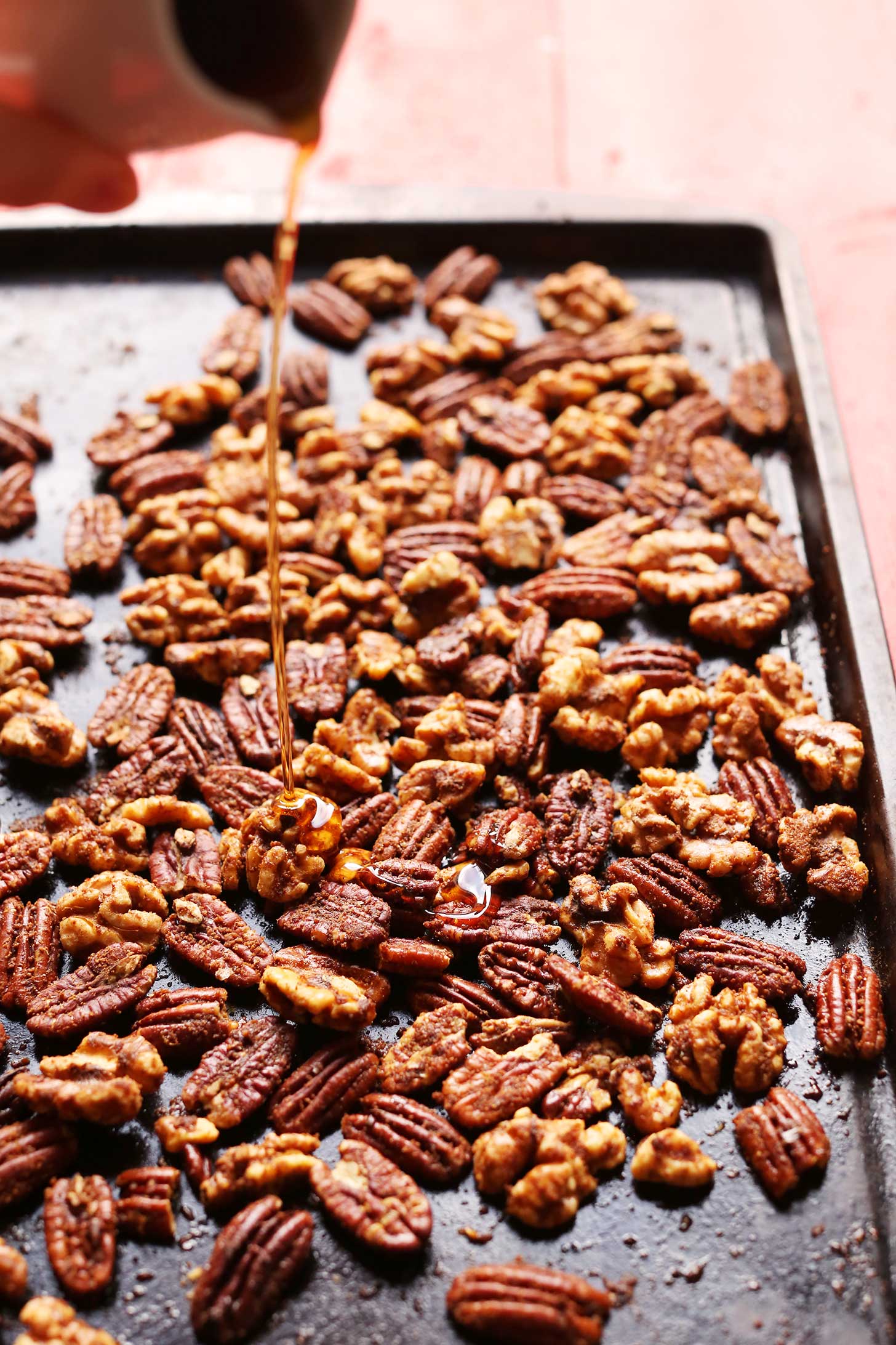 Pouring syrup onto nuts for our homemade holiday gift idea of Roasted Candied Nuts