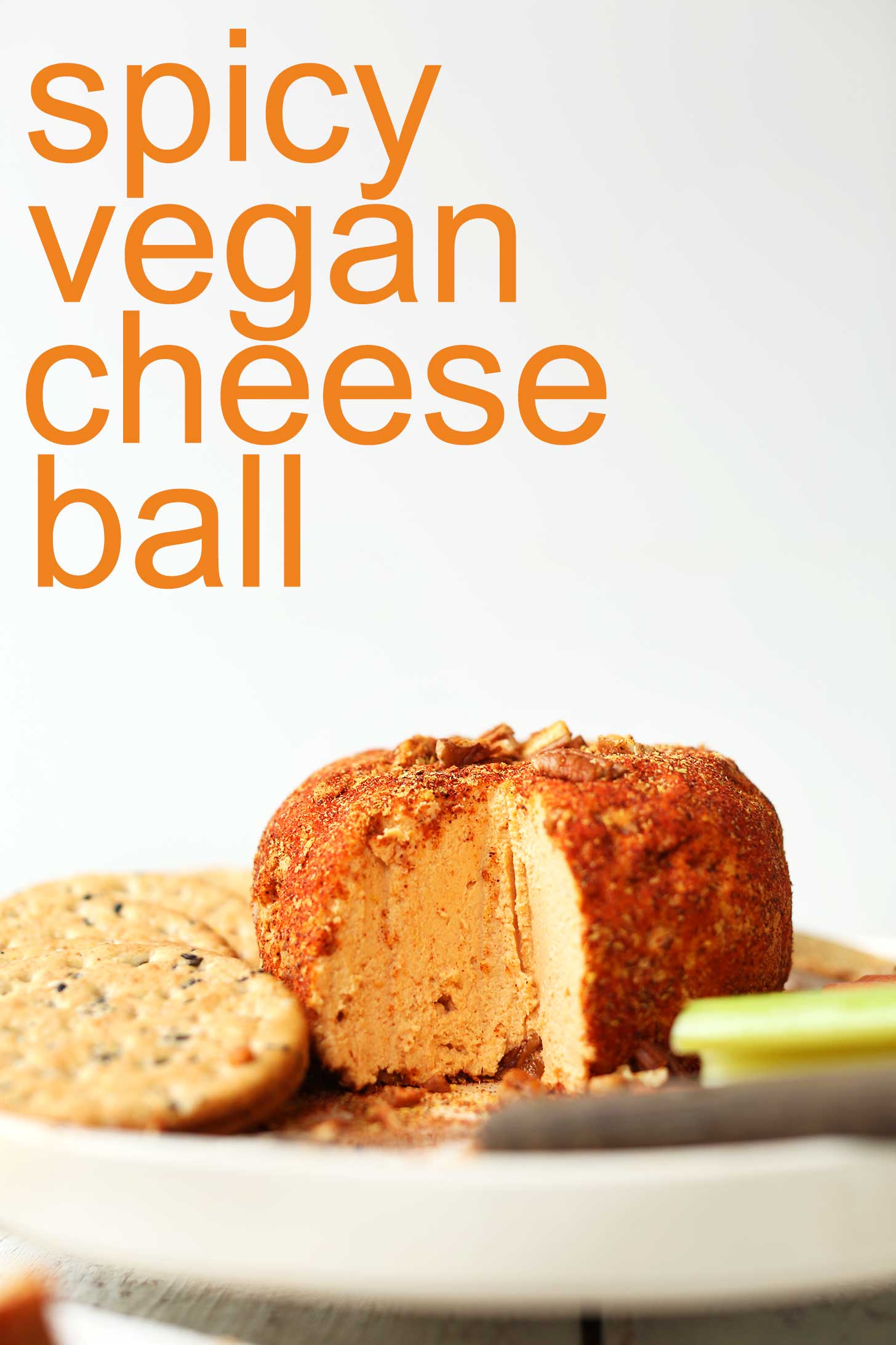 Spicy Vegan Cheese Ball on a plate with crackers and veggies for a holiday appetizer