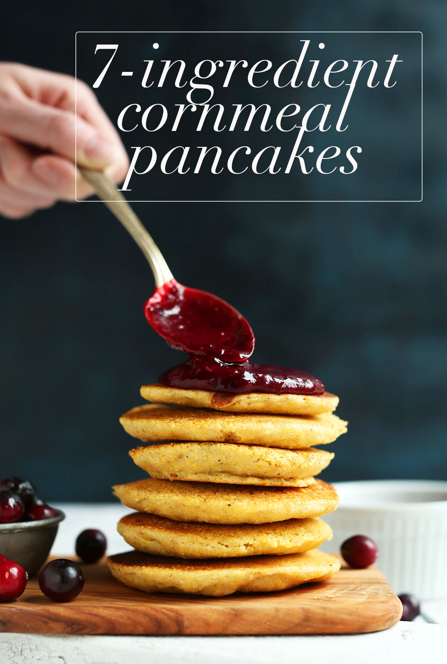 Spreading cranberry compote onto gluten-free vegan cornmeal pancakes
