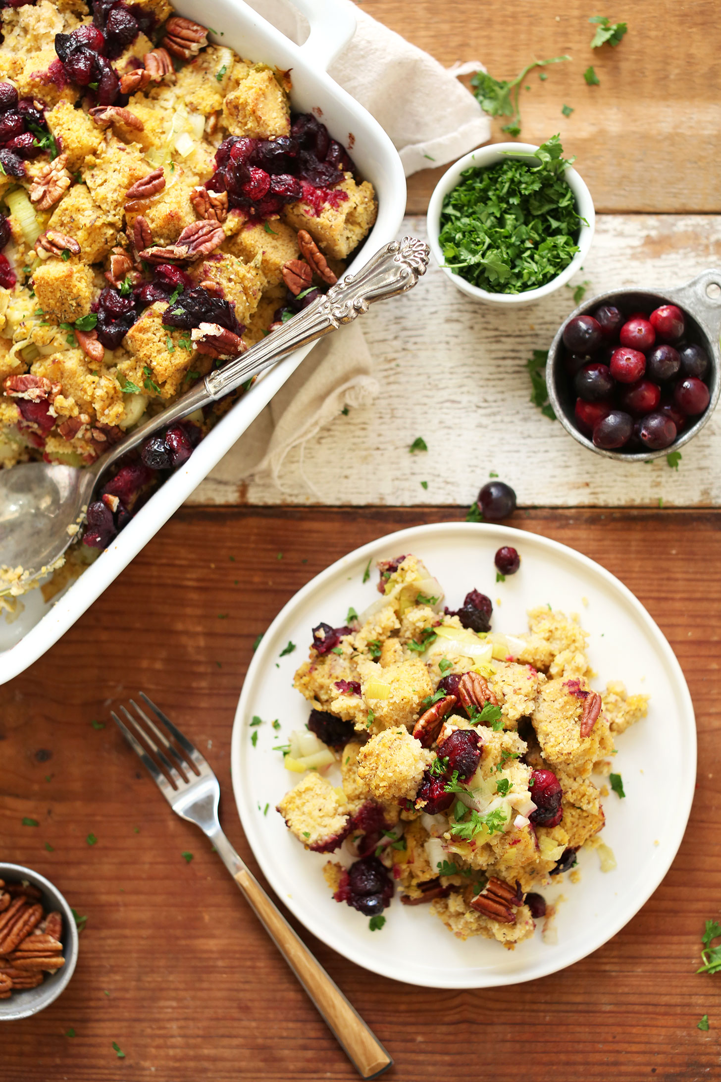 Baking dish and plate of Gluten-Free Vegan Cornbread Stuffing for Thanksgiving