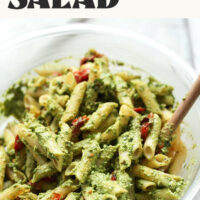 Bowl of our vegan penne pasta salad with roasted tomatoes with text above it saying ready in 30 minutes