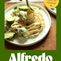 Swirling a bite of dairy-free garlic alfredo on a fork