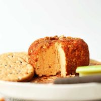 Plate with crackers, celery sticks, and a Spicy Vegan Cheese Ball
