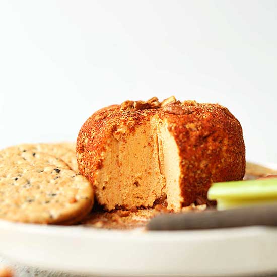 Plate with crackers, celery sticks, and a Spicy Vegan Cheese Ball