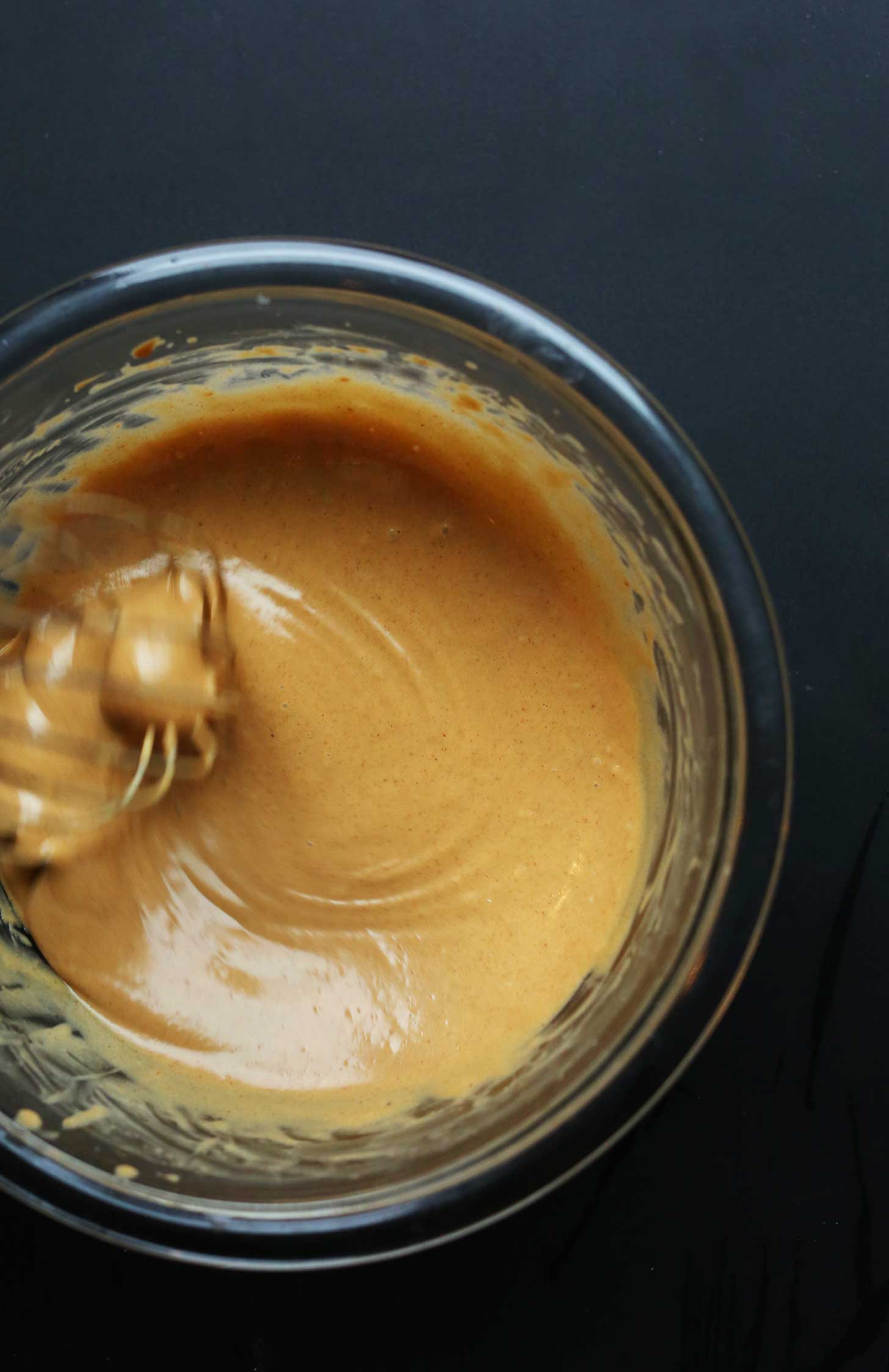 Whisking sauce ingredients for Marinated Peanut Tempeh