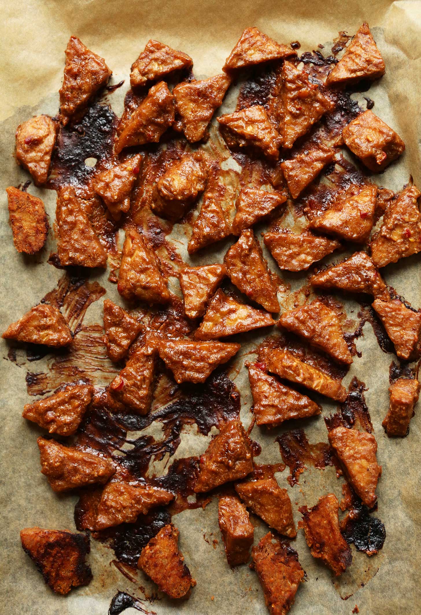Parchment-lined baking sheet filled with freshly baked Peanut Tempeh