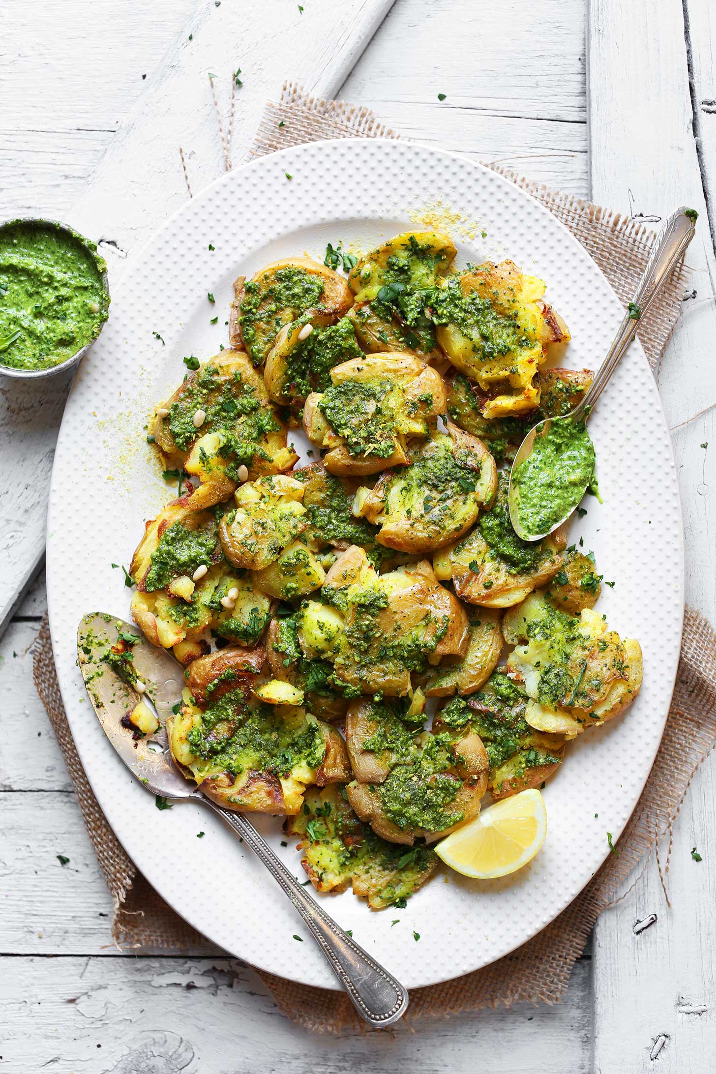 Platter full of Smashed Potatoes with Garlic Herb Pesto