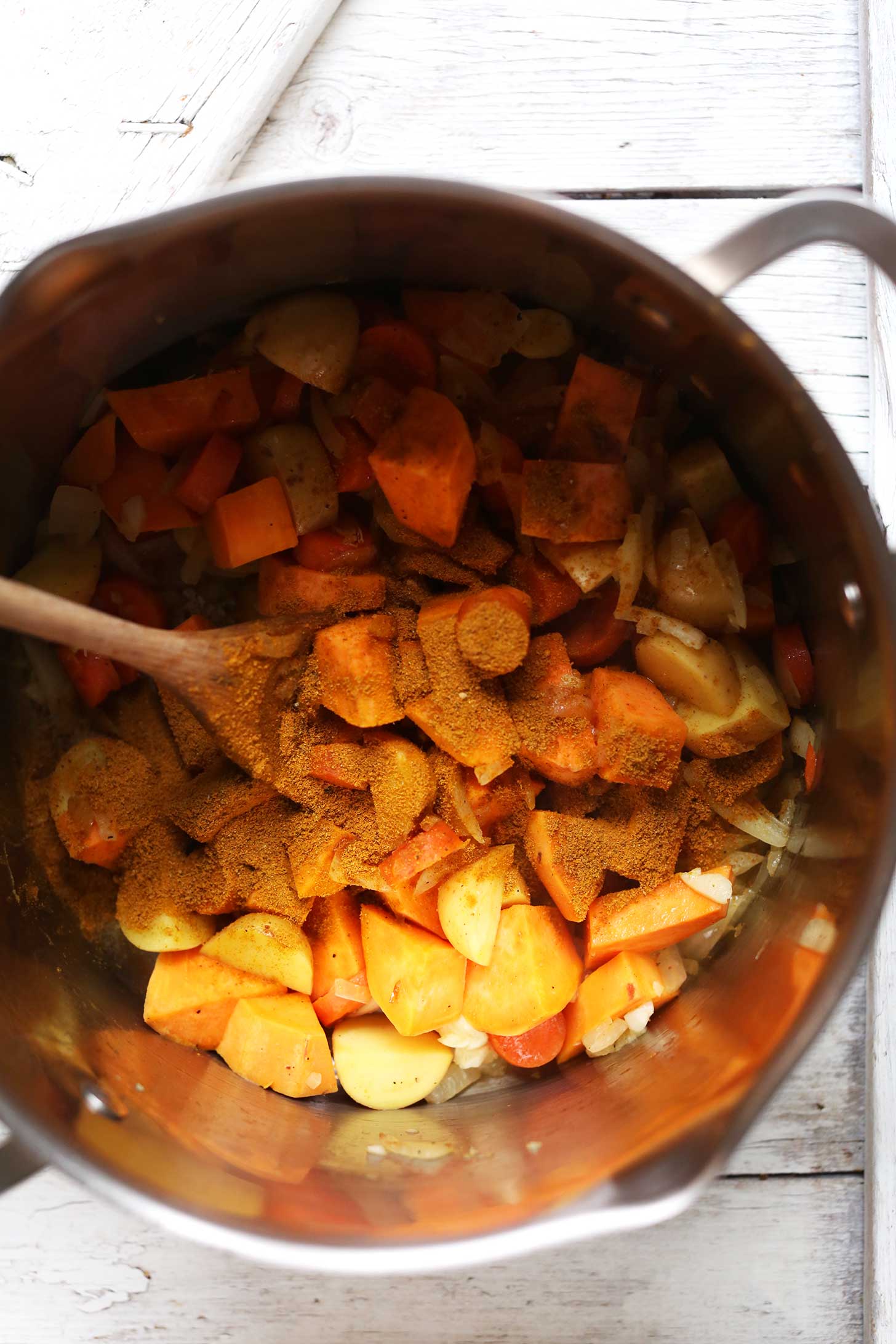 Stirring spices into vegetables for healthy 1-pot Curry Soup with lentils and veggies