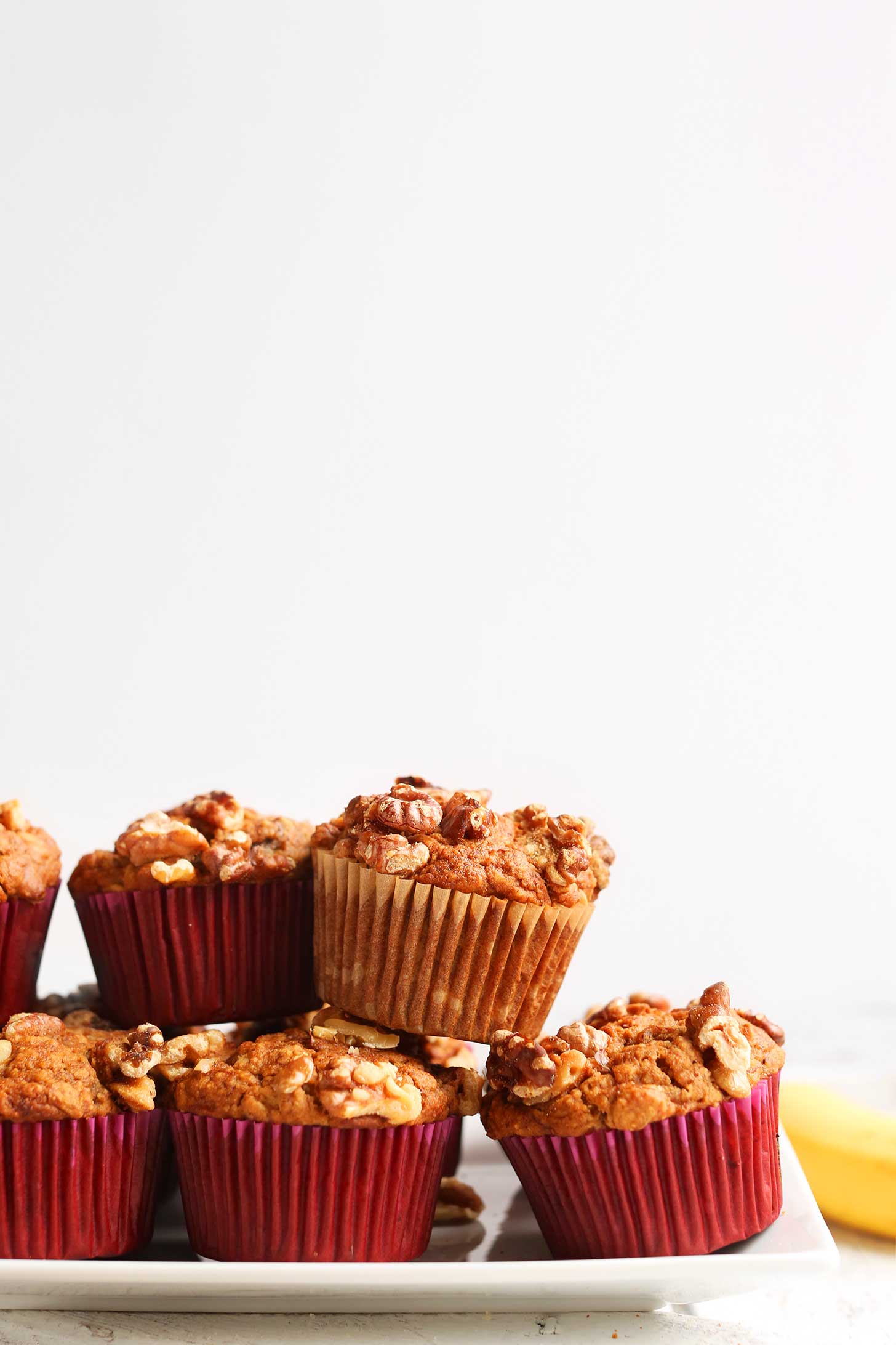 Plate stacked with the Best Vegan Gluten-Free Banana Nut Muffins