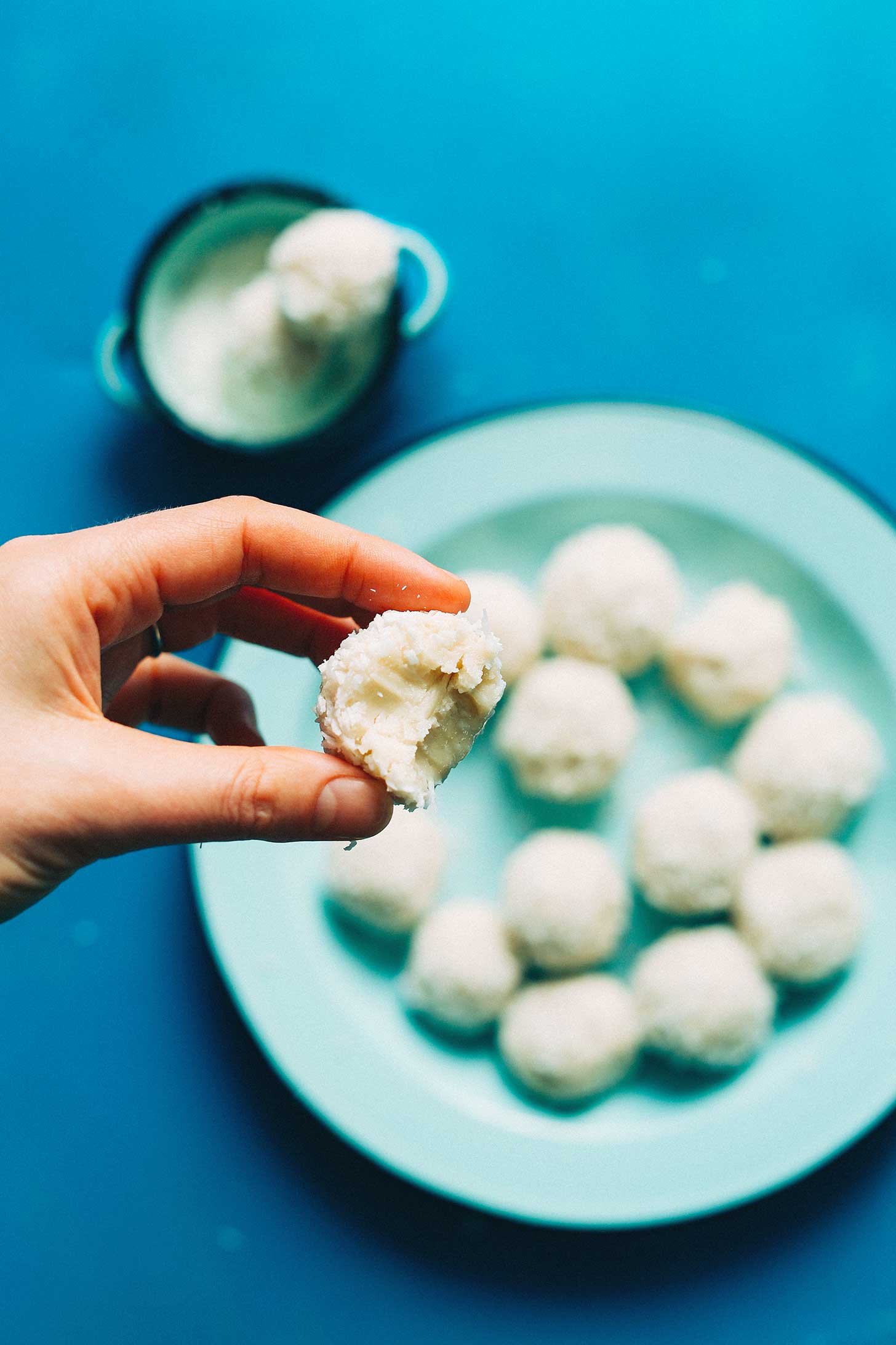 Half eaten gluten-free Vegan White Chocolate Truffle pulled from a plate