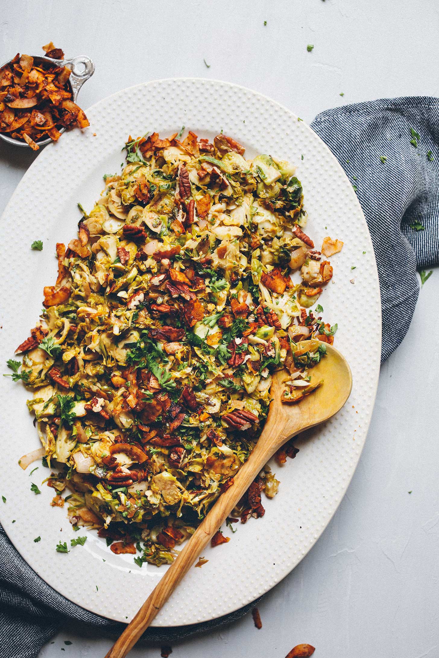 Big serving platter filled with Warm Brussel Sprout Slaw with vegan Coconut Bacon
