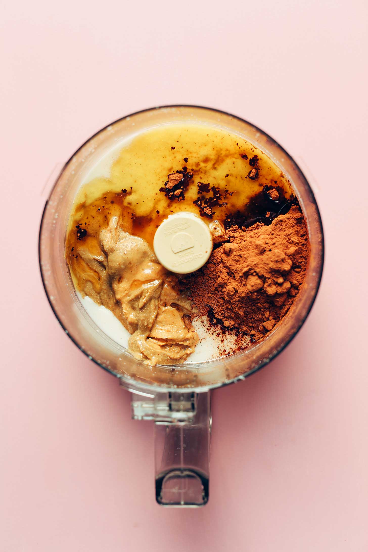 Food processor with ingredients for making our healthy vegan fudge recipe