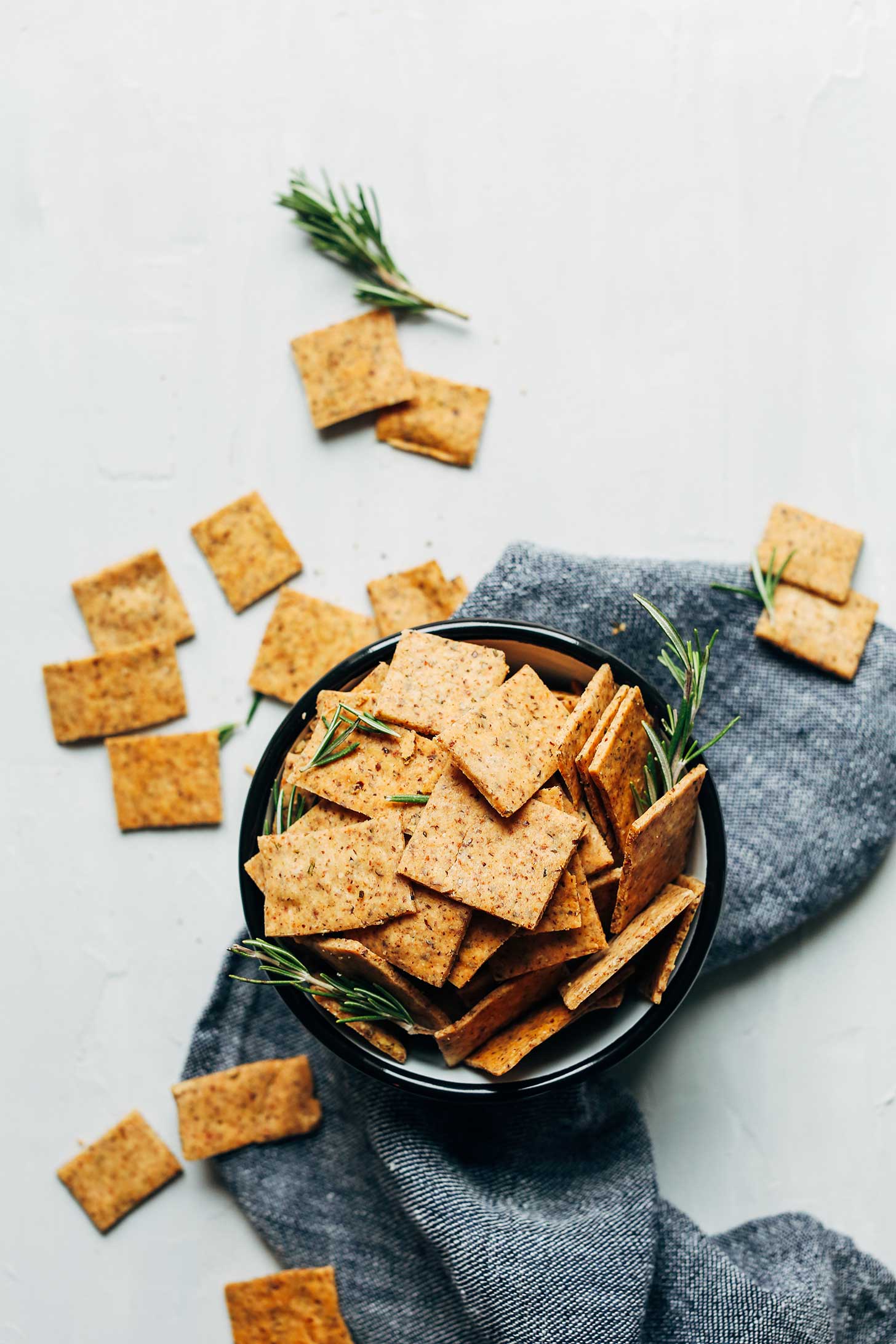 Bowl of crispy and delicious Vegan Gluten-Free Crackers with sprigs of rosemary